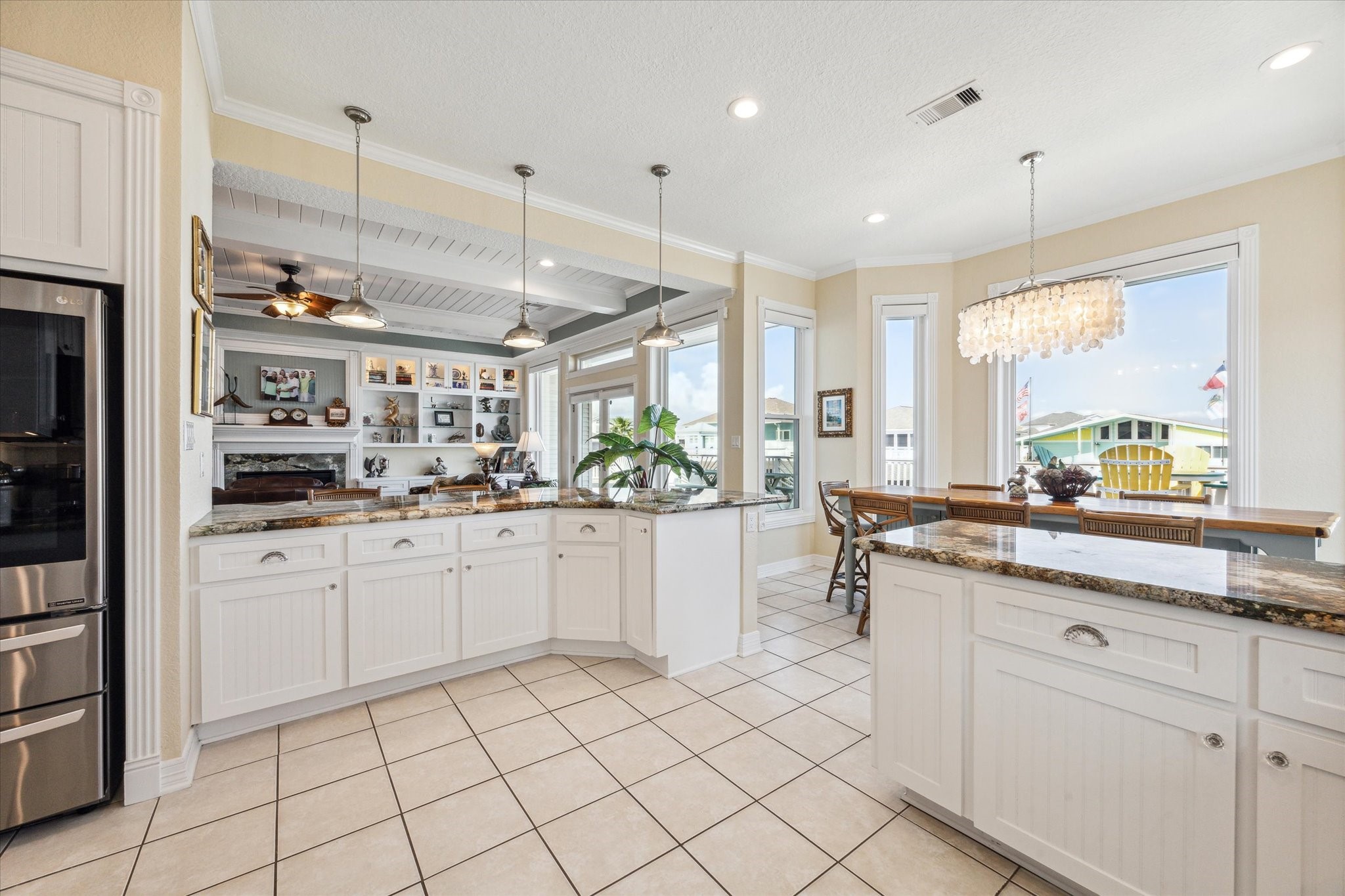 The seamless flow from the kitchen to the breakfast room and living room creates an ideal space for entertaining, allowing everyone to stay connected and be part of the conversation.