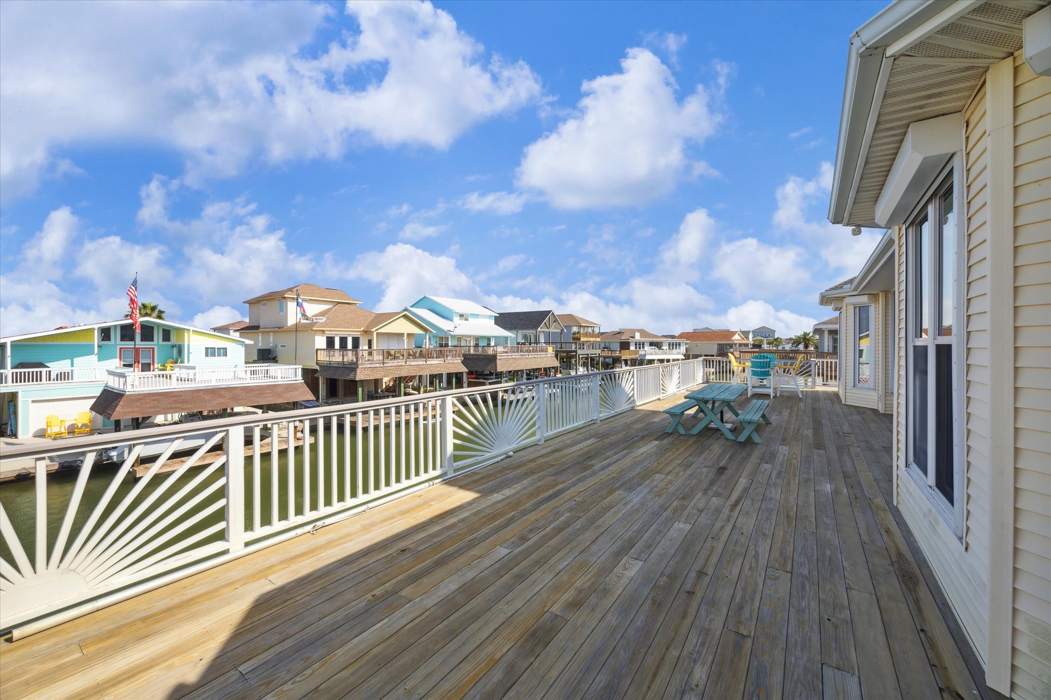 Off of the living room is access to your second level deck that expands across the back of the whole home. The deck was updated with treated wood, Trex railing and custom sunburst details. There is plenty of space to dine, relax and enjoy the views overlooking the water.