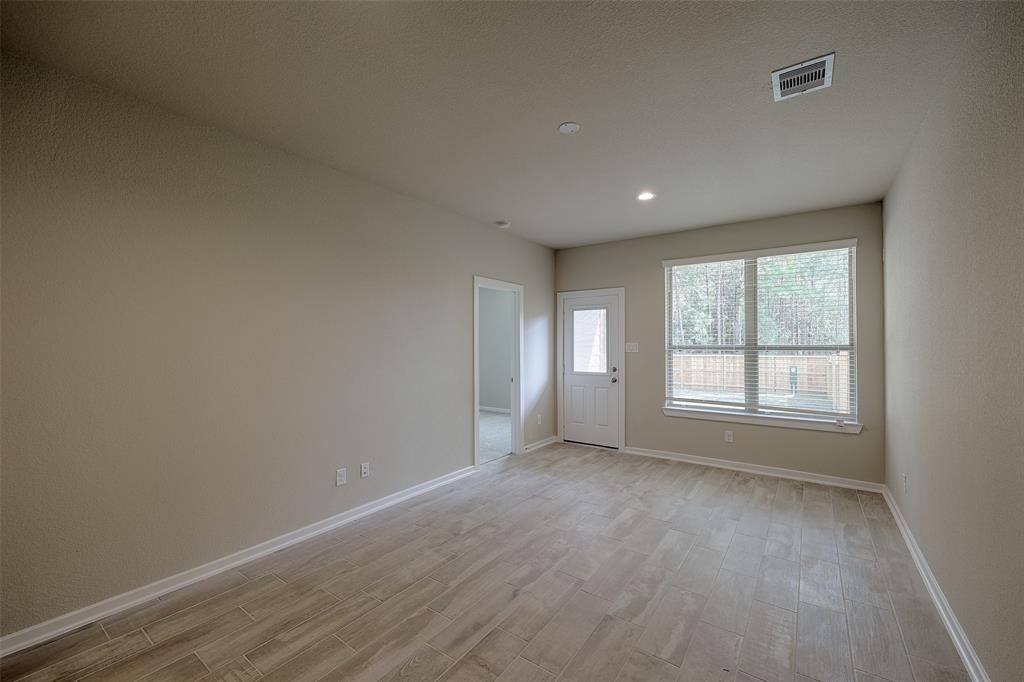 Ground level flex living area overlooks patio and large fenced, greenbelt back yard that is maintained by the landlord