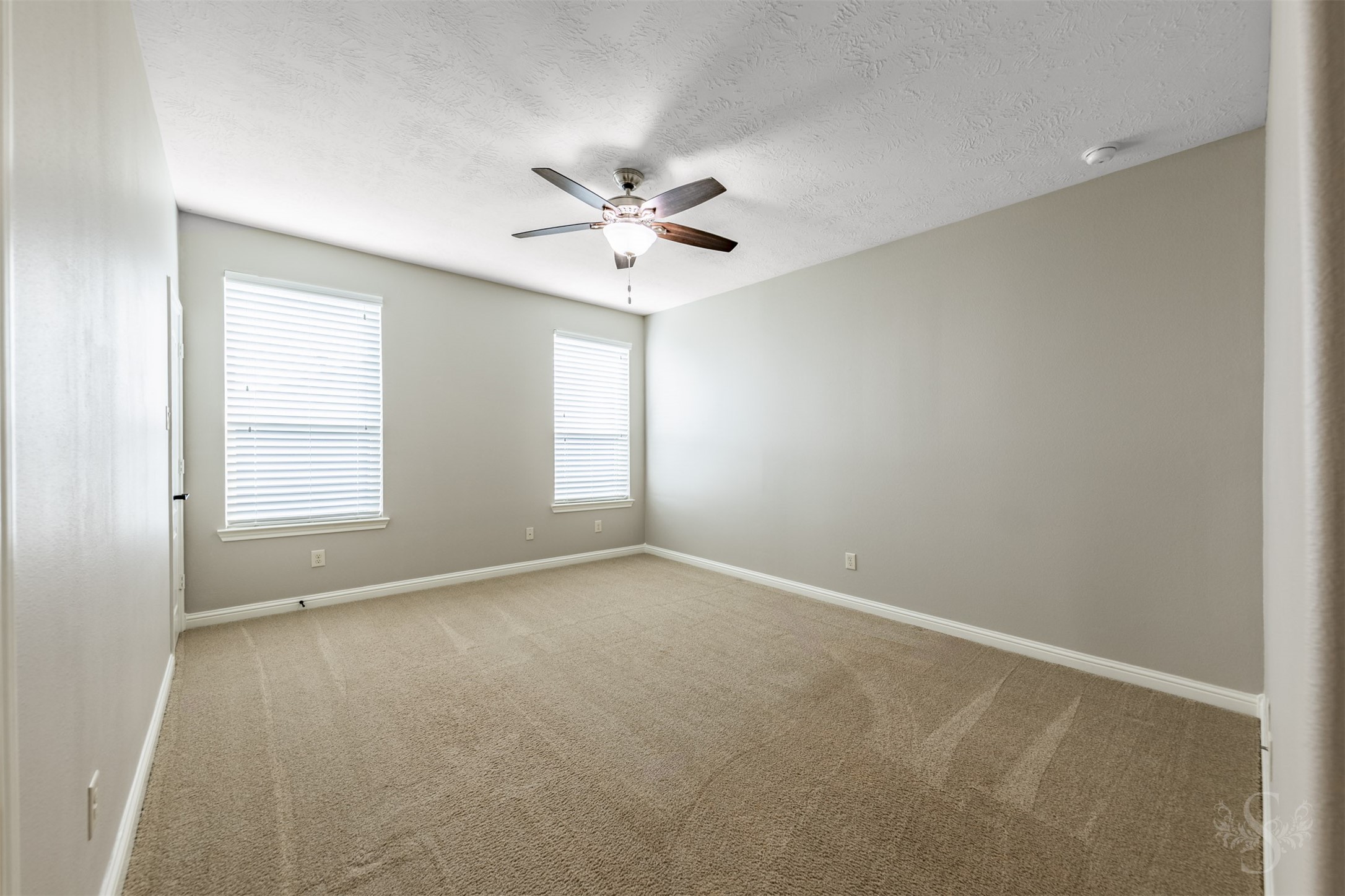 This spacious upstairs bedroom offers abundant room for a full bedroom furniture arrangement. Theres plenty of additional space for a desk, creating a comfortable place to study or pursue creative projects.
