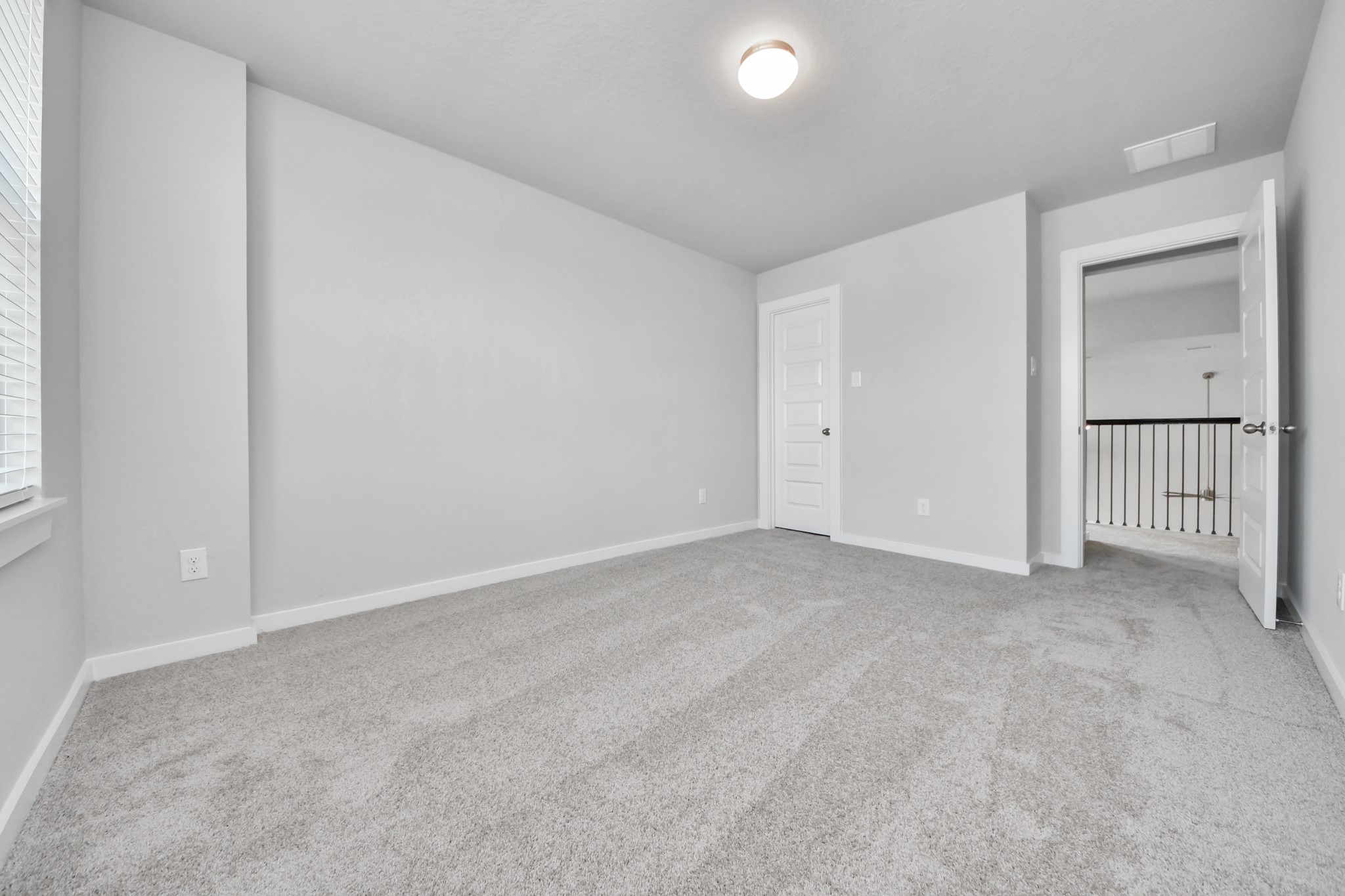 Generously sized secondary bedrooms featuring spacious closets, soft and inviting carpeting underfoot, large windows allowing plenty of natural light, and the added touch of privacy blinds for your personal retreat. Sample photo of completed home with similar floor plan. Actual colors and selections may vary.