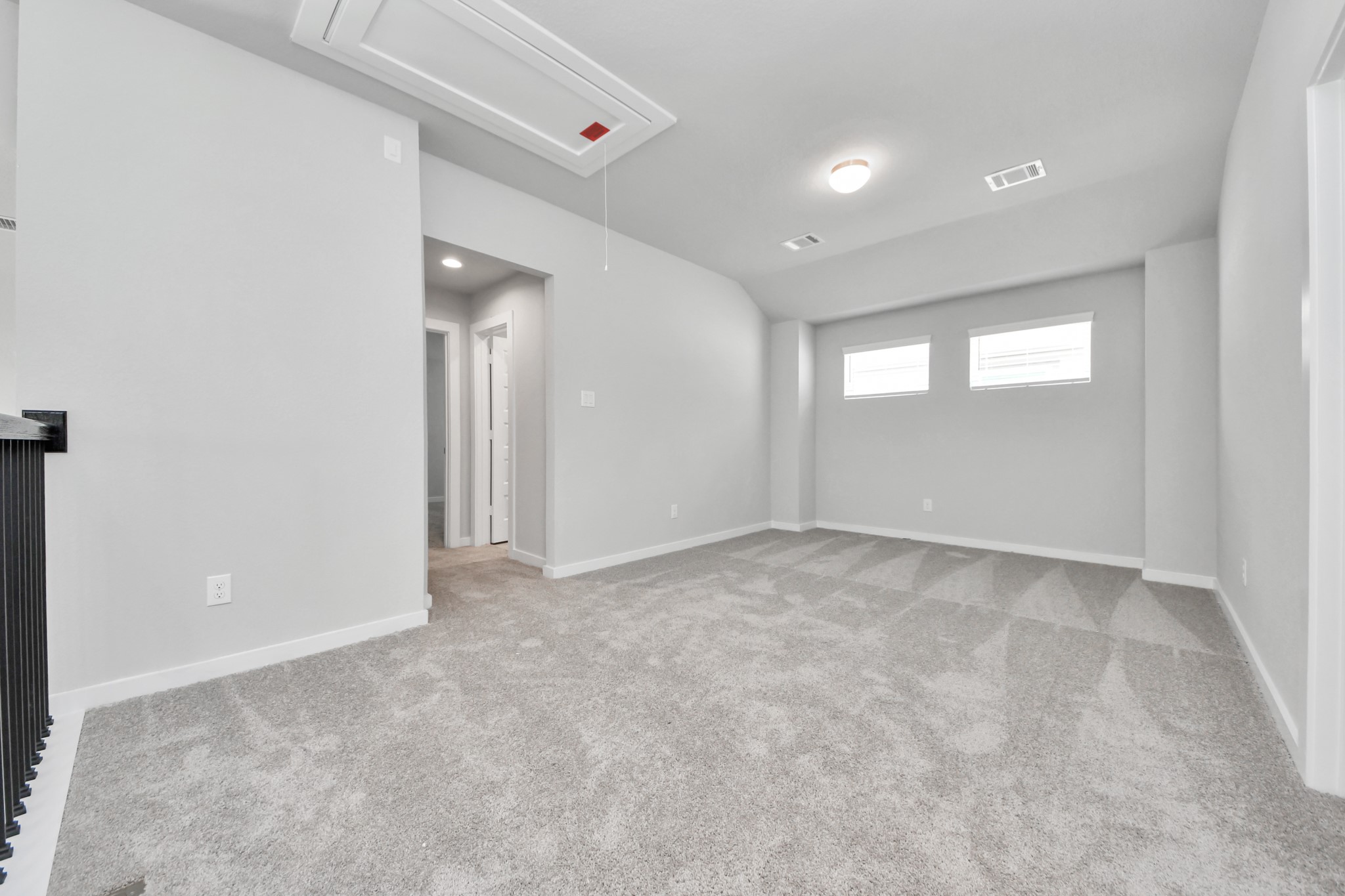 Ascend to relaxation in this fantastic game room! Ideal for both casual gatherings and adult gaming, it boasts plush carpet, lofty ceilings, custom paint, and ample windows for abundant natural light. Sample photo of completed home with similar floor plan. Actual colors and selections may vary.