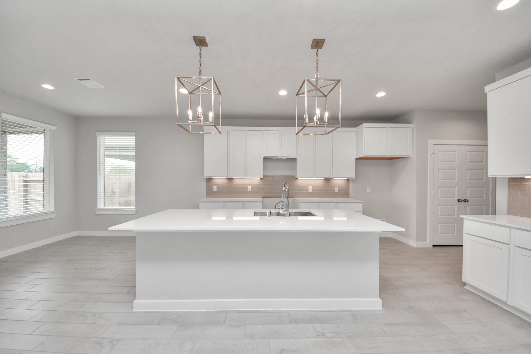 This kitchen is by far any chefs dream! This spacious kitchen features high ceilings, light stained wood cabinets, granite countertop, SS appliances, modern tile backsplash, recessed lighting, extended counter space, granite kitchen island with double sink, and space for breakfast bar, and a walk-in pantry all overlooking your huge family room. Sample photo of completed home with similar floor plan. Actual colors and selections may vary.
