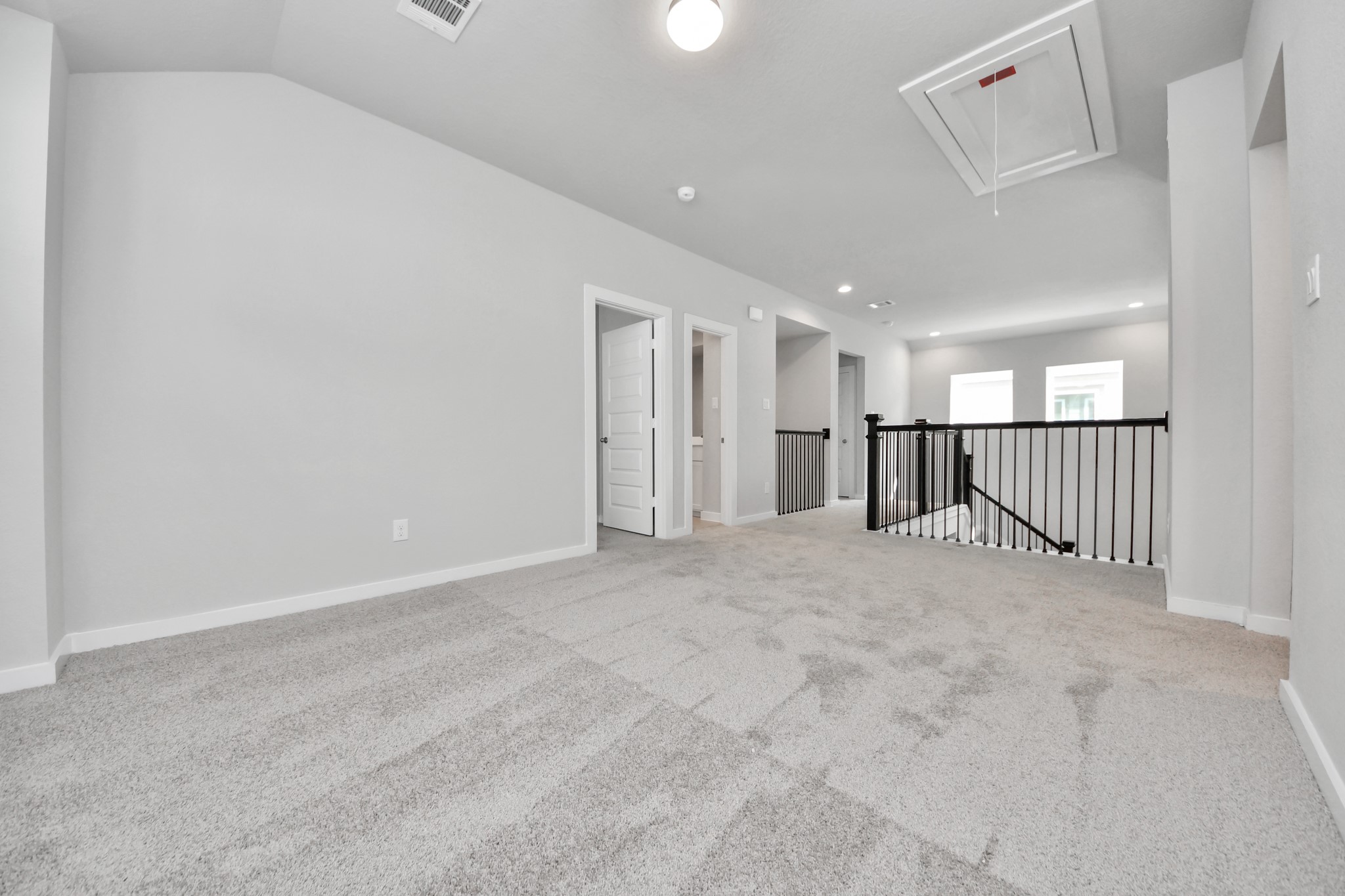 Come upstairs and enjoy a day of leisure in this fabulous game room! This is the perfect hangout spot or adult game room! Features plush carpet, high ceilings, custom paint and windows for plenty of natural light. Sample photo of completed home with similar floor plan. Actual colors and selections may vary.