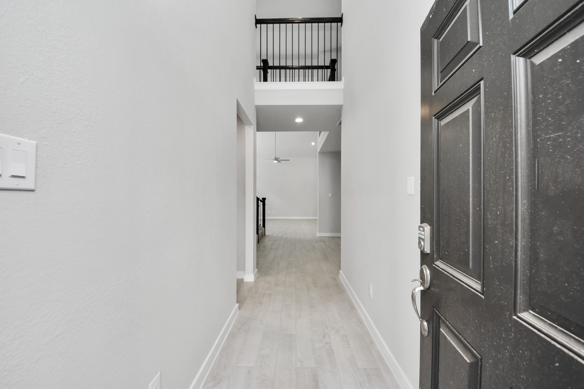 As you step into the threshold of this luxurious home, you'll soon be welcomed by an elegant glass door (to be installed). Inside, soaring ceilings amplify the spaciousness, while the refined wood-look tile flooring and oversized baseboards exude sophistication and charm. Sample photo of completed home with similar floor plan. Actual colors and selections may vary.
