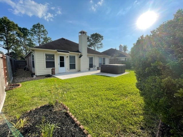 Charming backyard with a spacious patio, lush lawn, perfect for outdoor entertaining and relaxation. Hot tub is being removed.