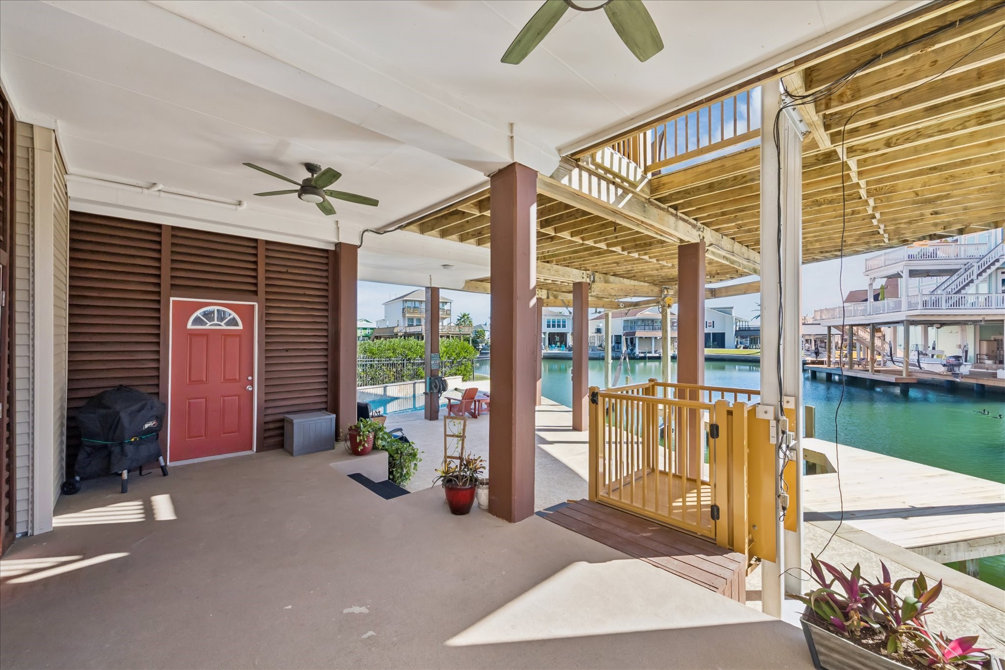Two levels of outdoor space provides generous overhead shade and multiple options to spread out just steps from the water. A conveniently located refrigerator keeps drinks and refreshments close at hand.