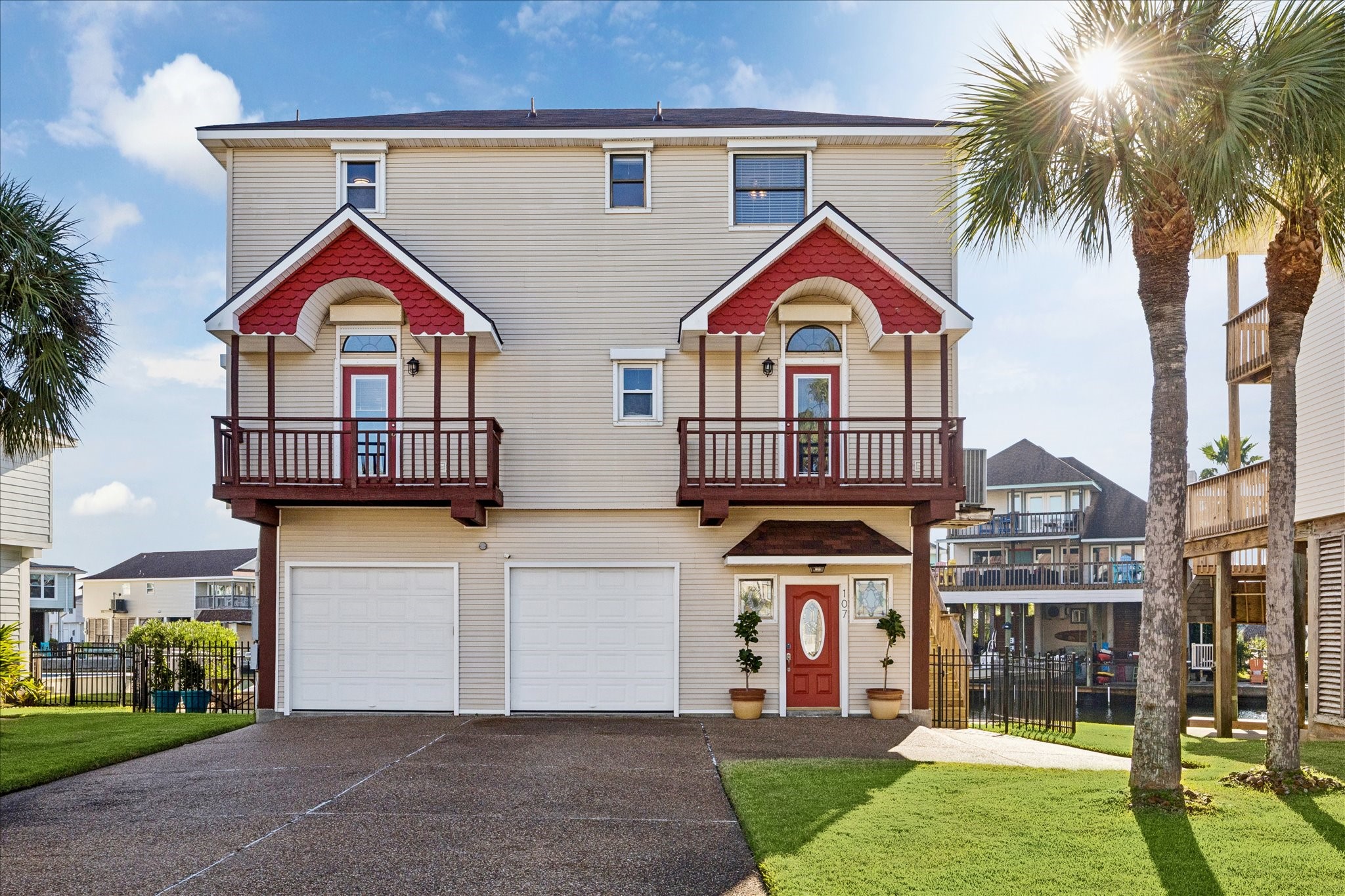 Two private balconies bring the living space outdoors, offering separate places to enjoy the island air. Spacious driveway plus additional parking nook accommodate up to 10 vehicles. Two colorful stained-glass windows greet you at the front entry.
