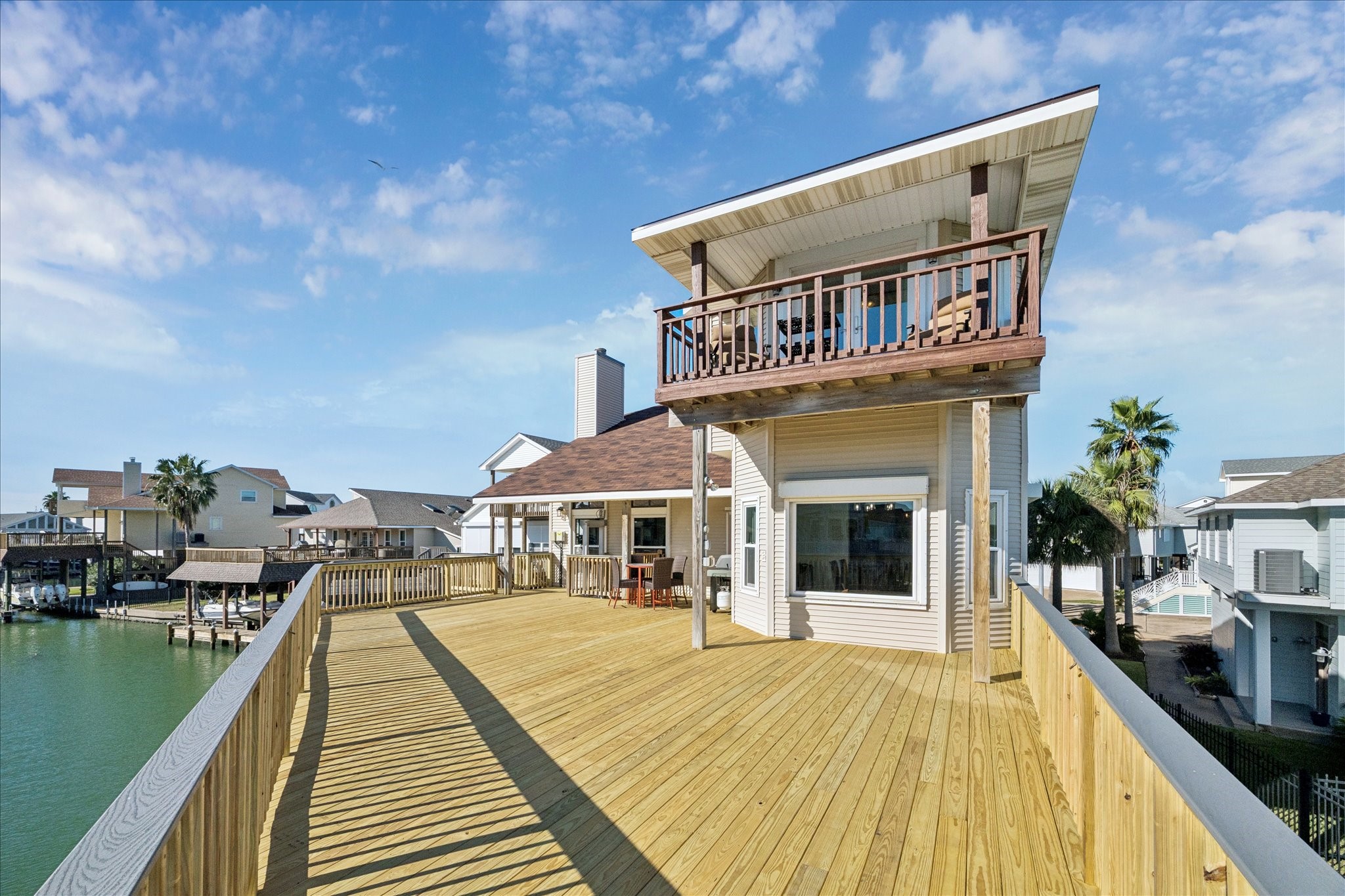 The primary suite's balcony creates a personal retreat, set apart from the home's expansive main deck below.