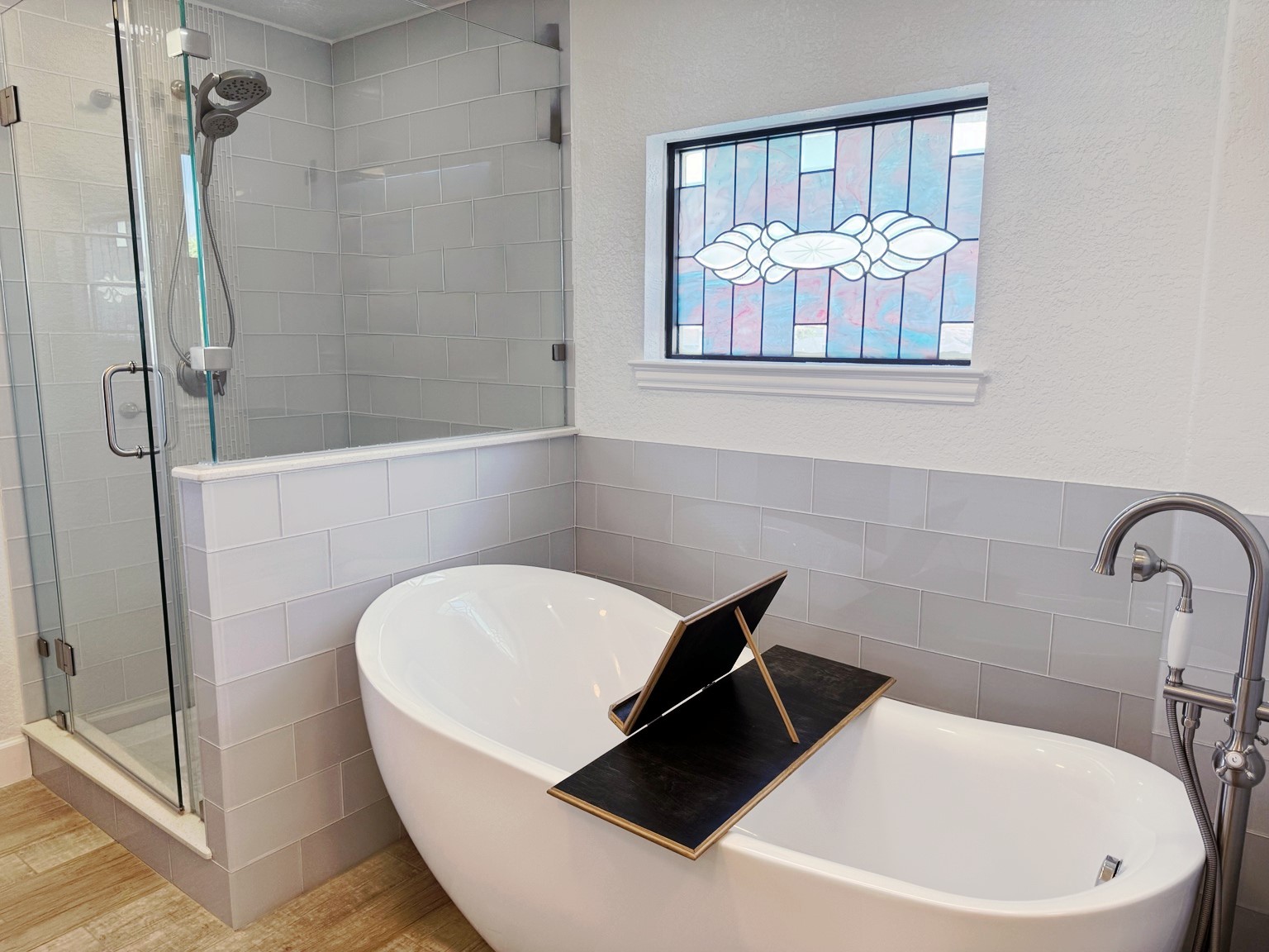 A freestanding tub and separate walk-in shower continue the spa-like experience, whether you prefer a leisurely soak or a refreshing shower.