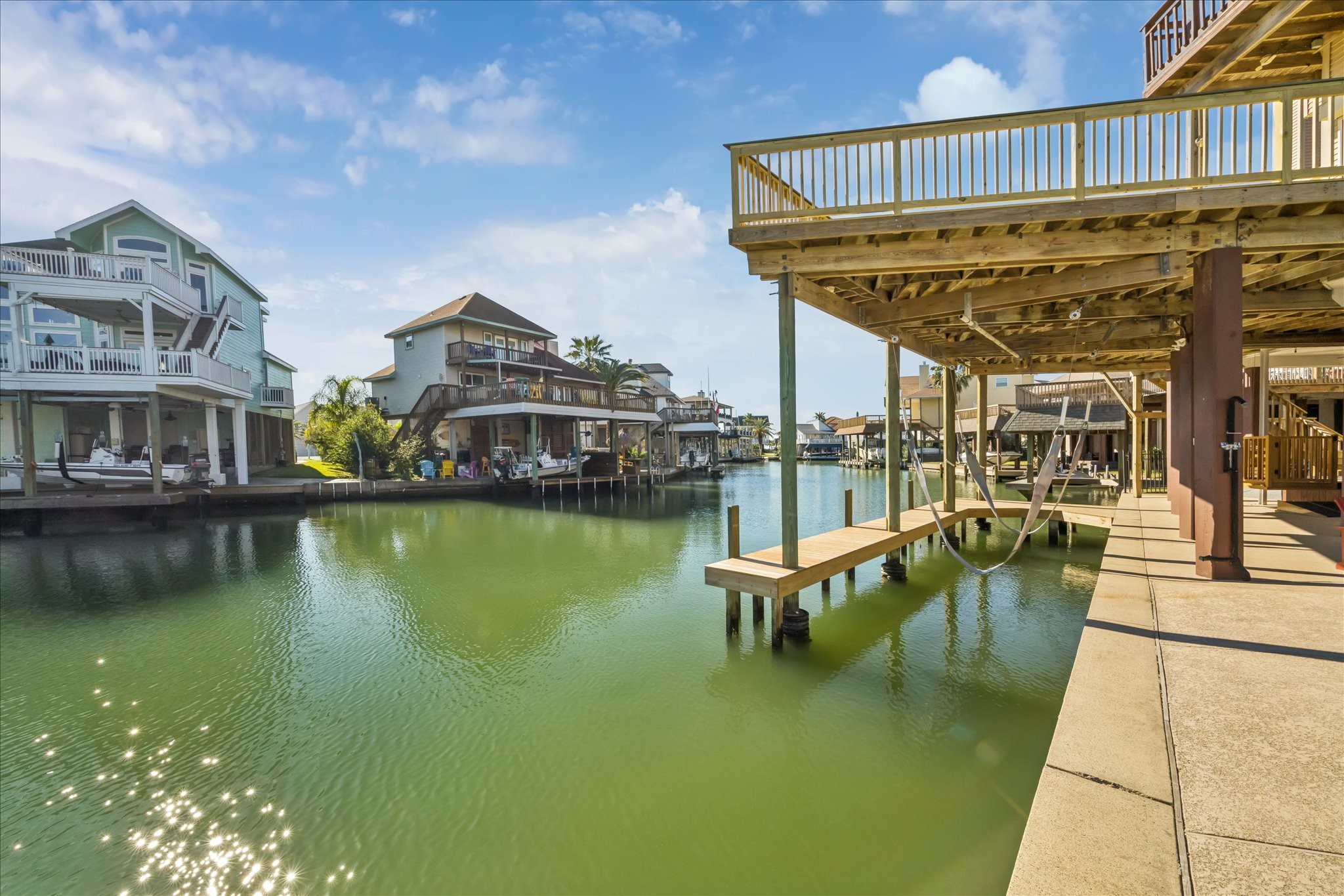 89 feet of deep waterfront supported by a concrete bulkhead provides room for multiple people to fish from the pier/dock or bulkhead. The covered boat slip and advantageous canal location provide exceptionally easy-in, easy-out access.
