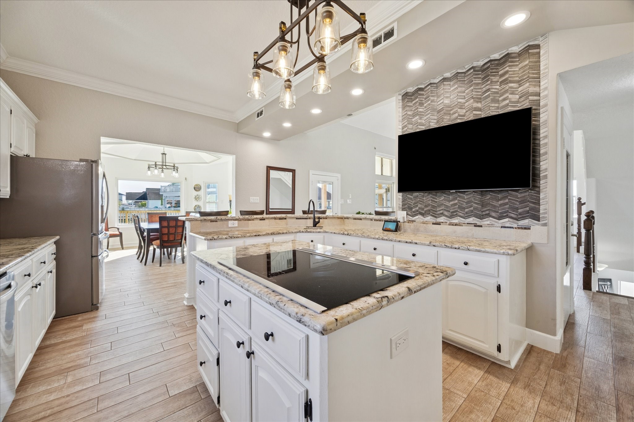 A wraparound bar seats six, while the pull-and-swivel TV adds a fun touch for game day. Point the TV toward the dining area when the conversations move to the dining table.