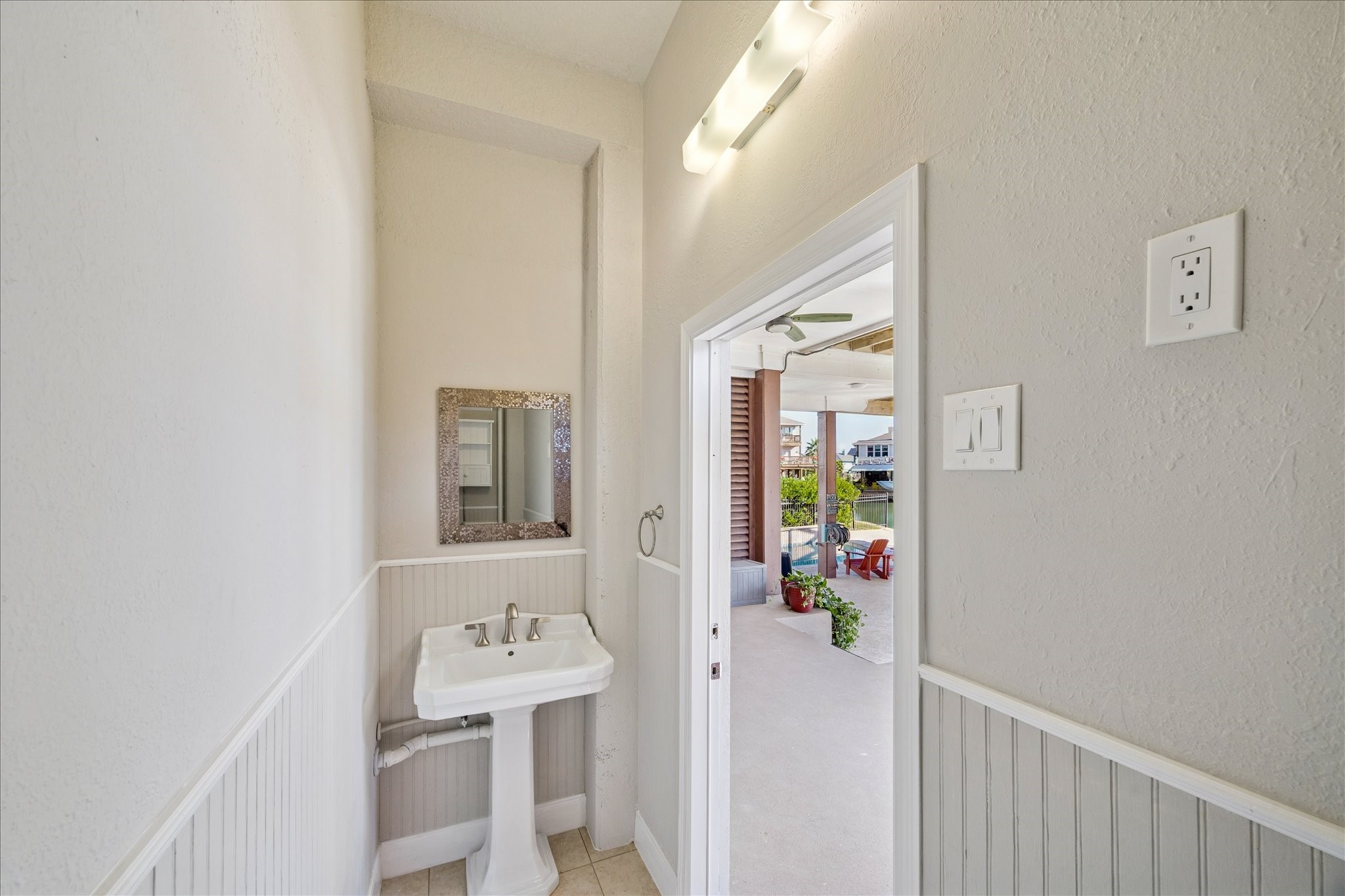 The pool-level bathroom keeps wet feet downstairs and adds convenience for swimmers, boaters and everyday outdoor living.