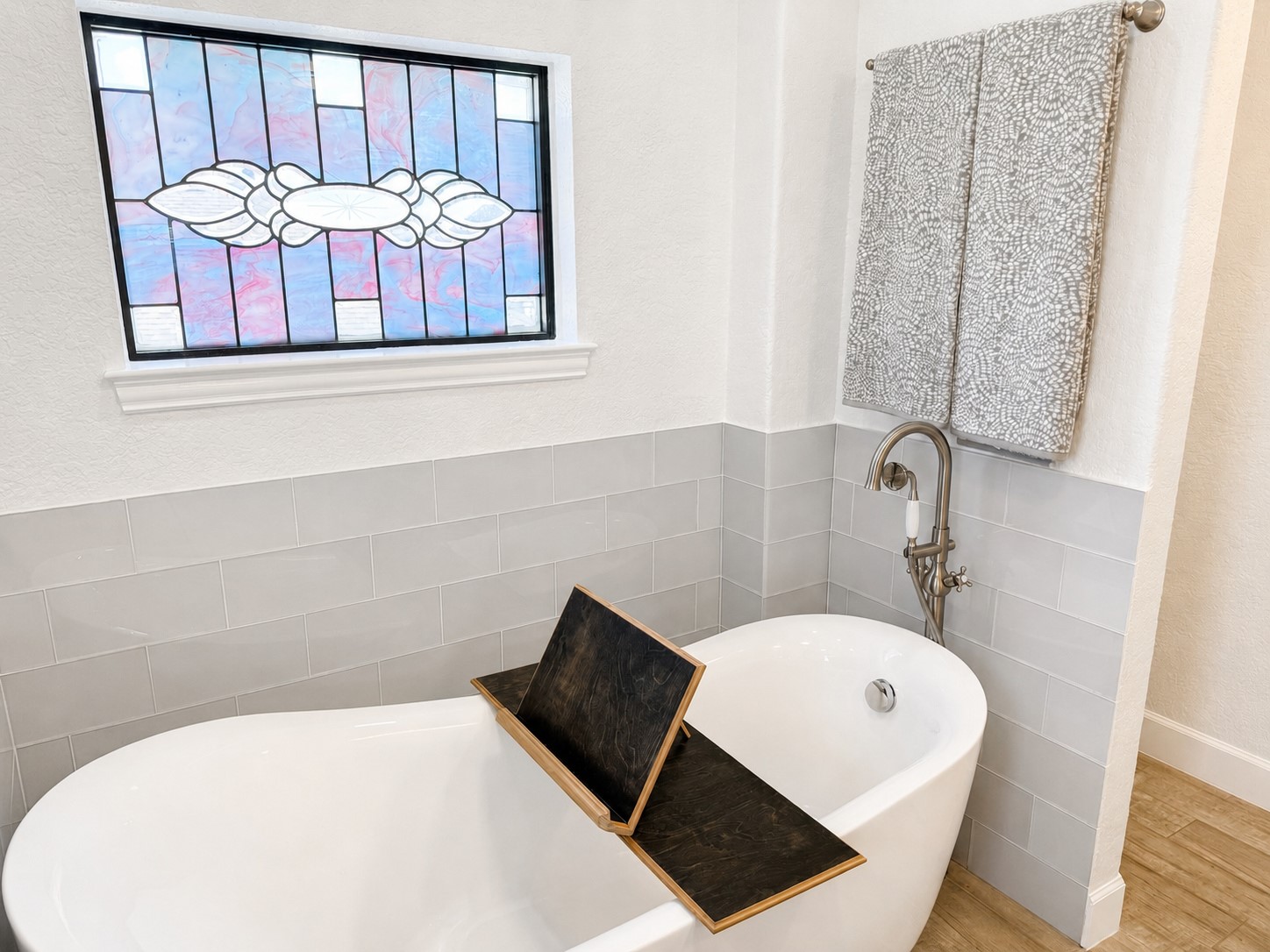 Settle in with a favorite book as light filters through the stained-glass window, creating a peaceful place to soak, read and escape from the everyday.