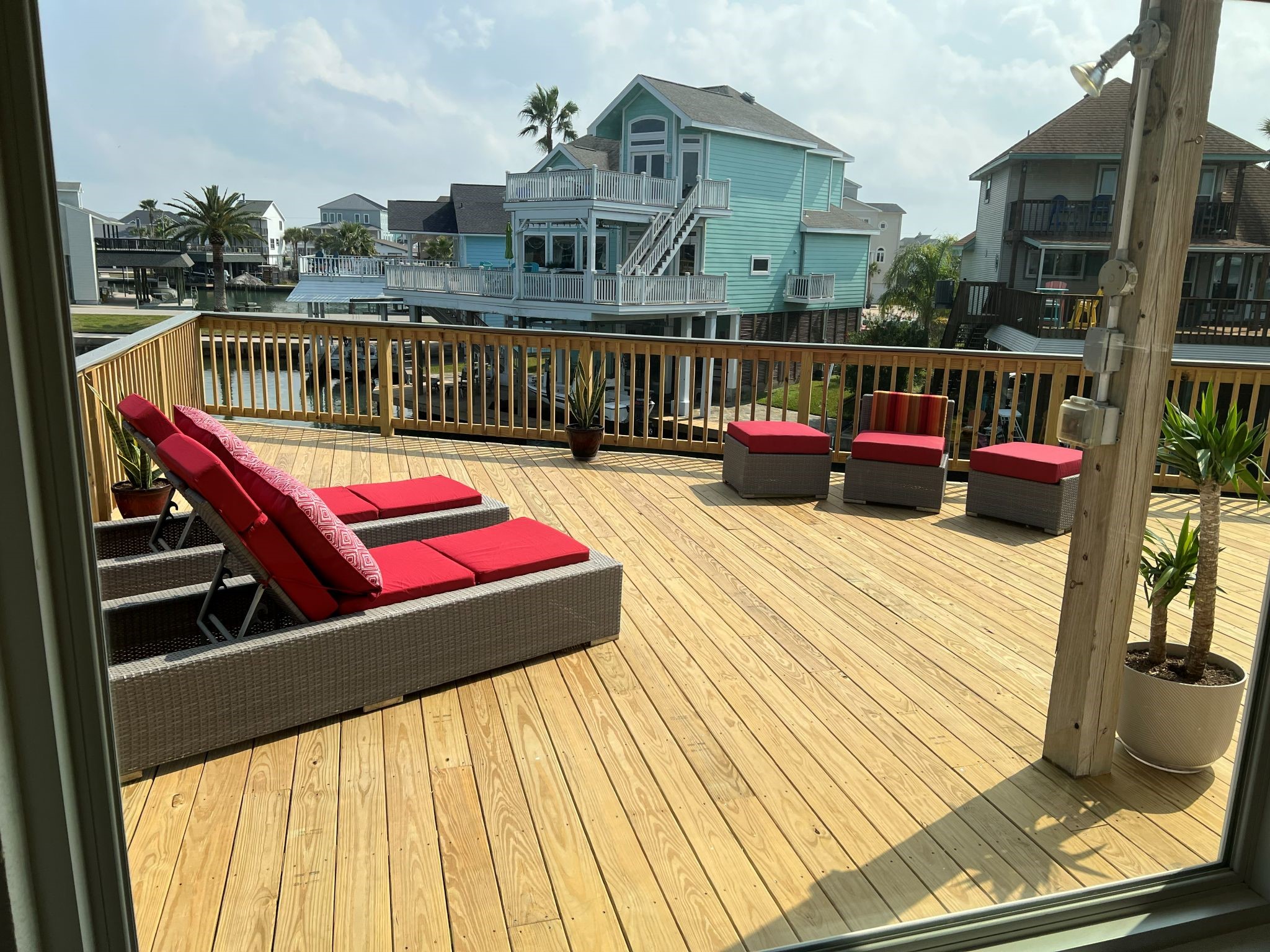 Water surrounds the deck on three sides, creating an immersive canal setting and front-row seat to the activity on the water.