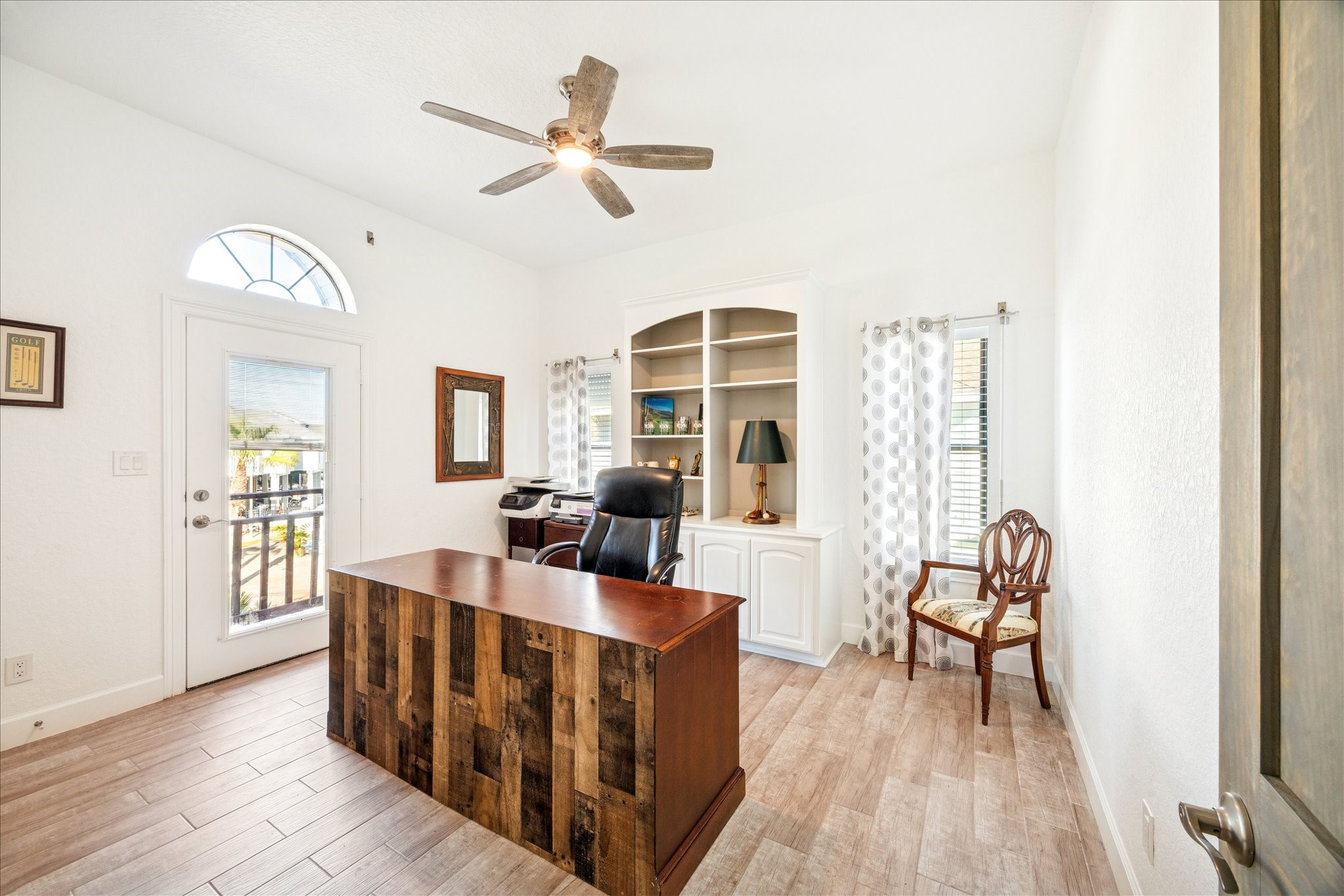 A view toward the canal and built-in millwork with display shelving and cabinets enhance this flexible bedroom or office. A double-door closet adds storage, while a private balcony gives the room its own outdoor escape.