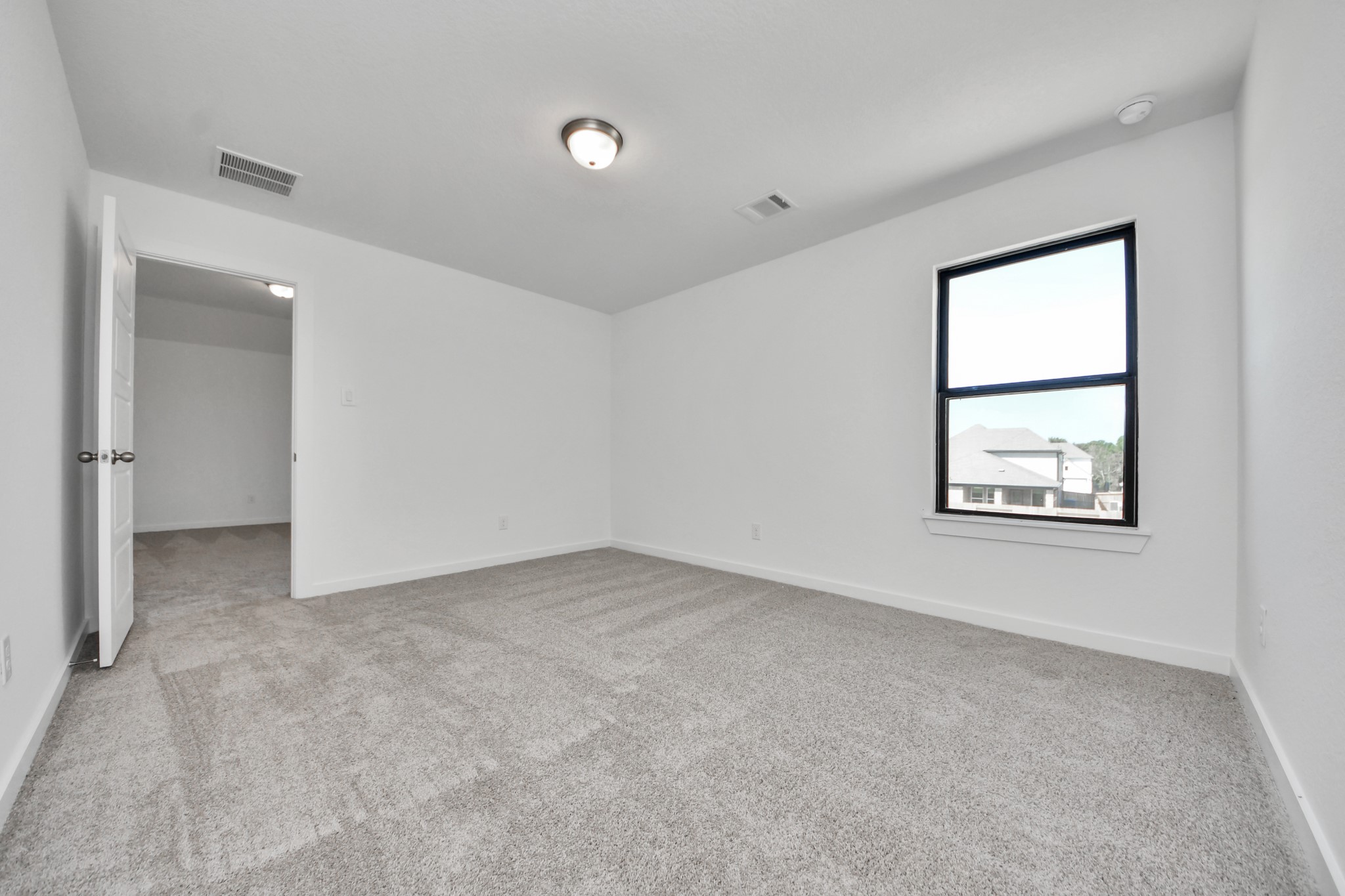 Generously sized secondary bedrooms featuring spacious closets, soft and inviting carpeting underfoot, large windows allowing plenty of natural light, and the added touch of privacy blinds for your personal retreat. Sample photo of completed home with similar floor plan. Actual colors and selections may vary.