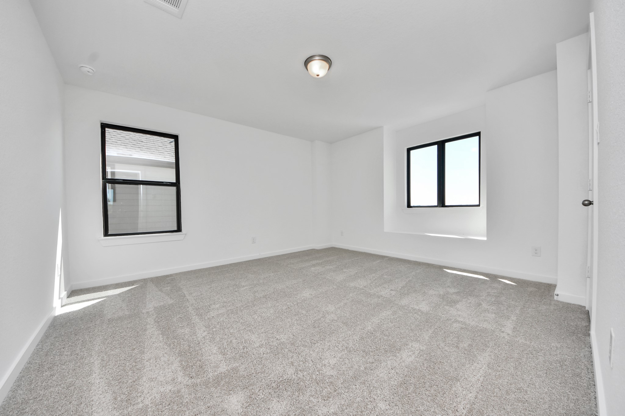 Generously sized secondary bedrooms featuring spacious closets, soft and inviting carpeting underfoot, large windows allowing plenty of natural light, and the added touch of privacy blinds for your personal retreat. Sample photo of completed home with similar floor plan. Actual colors and selections may vary.