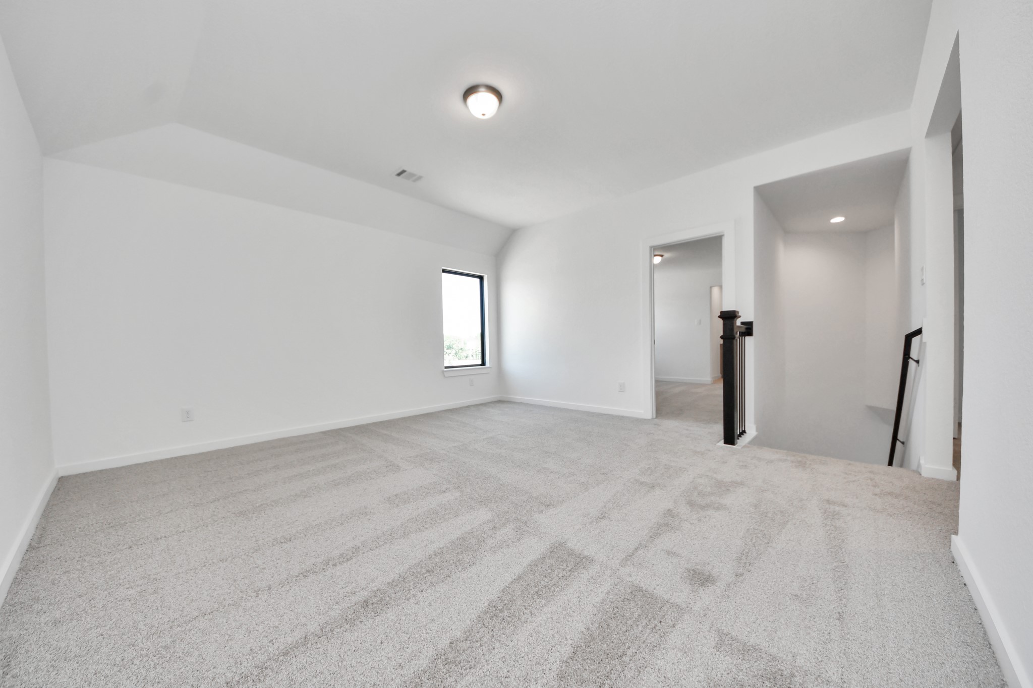 Come upstairs and enjoy a day of leisure in this fabulous game room! This is the perfect hangout spot or adult game room! Features plush carpet, high ceilings, custom paint and windows for plenty of natural light. Sample photo of completed home with similar floor plan. Actual colors and selections may vary.