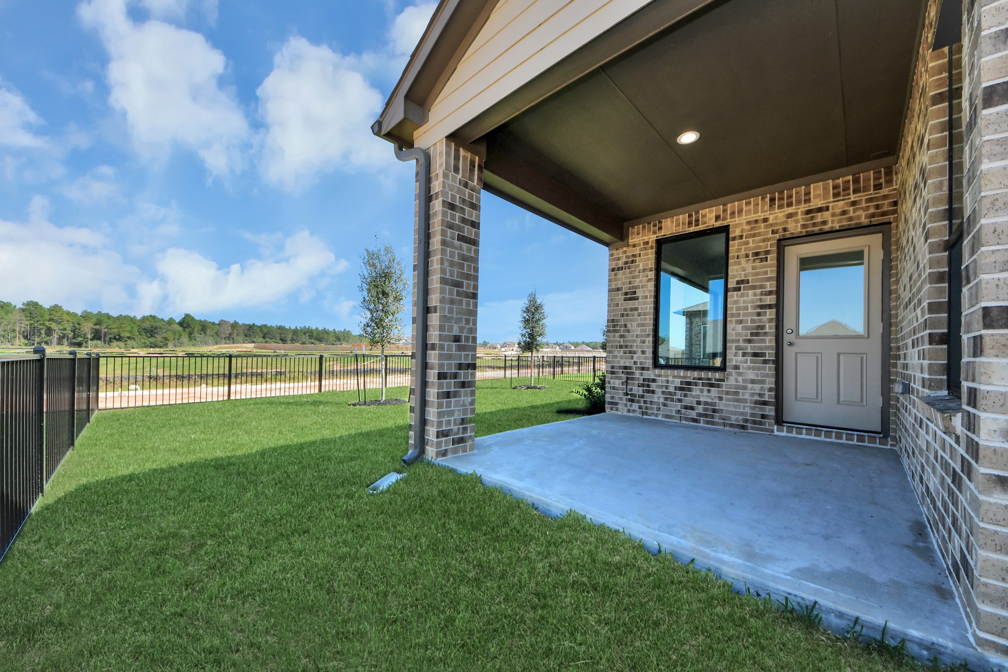 Come and see this spacious backyard with its beautiful covered patio. There is plenty of room for the kids to play and adults to relax. Perfect for your outdoor living space, patio furniture, bbq pit, and so much more. The possibilities are endless! Sample photo of completed home with similar floor plan. Actual colors and selections may vary.