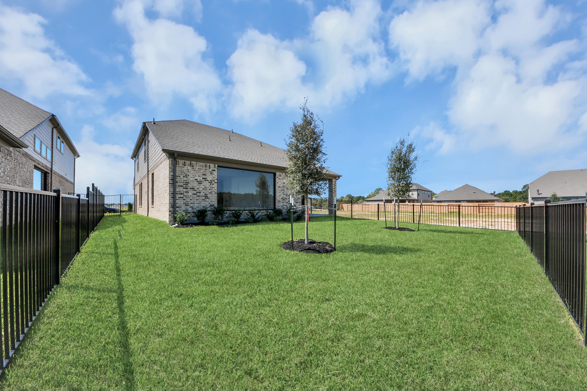 Experience outdoor living at its finest on this expansive covered patio, thoughtfully designed for BBQs and delightful outdoor dining. Sample photo of completed home with similar floor plan. Actual colors and selections may vary.