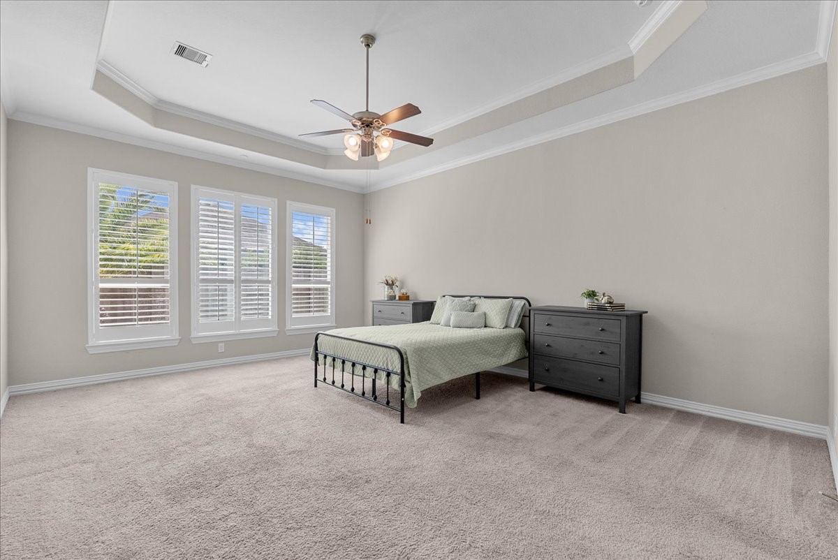 Plenty of room in this spacious primary suite for a cozy little sitting area as well.