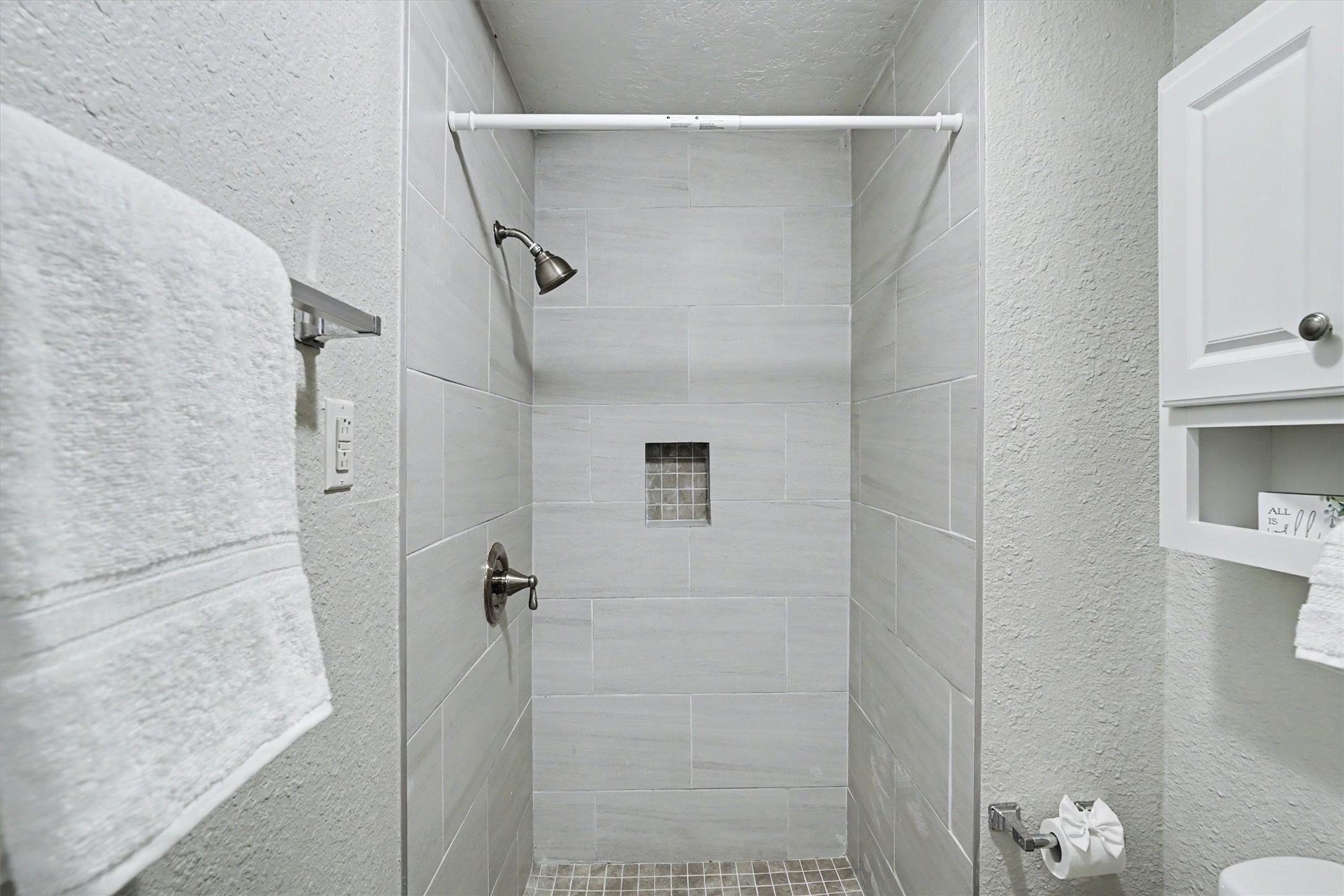 Built-in tiled shower with recessed niche, added during the 2022 bathroom remodel.
