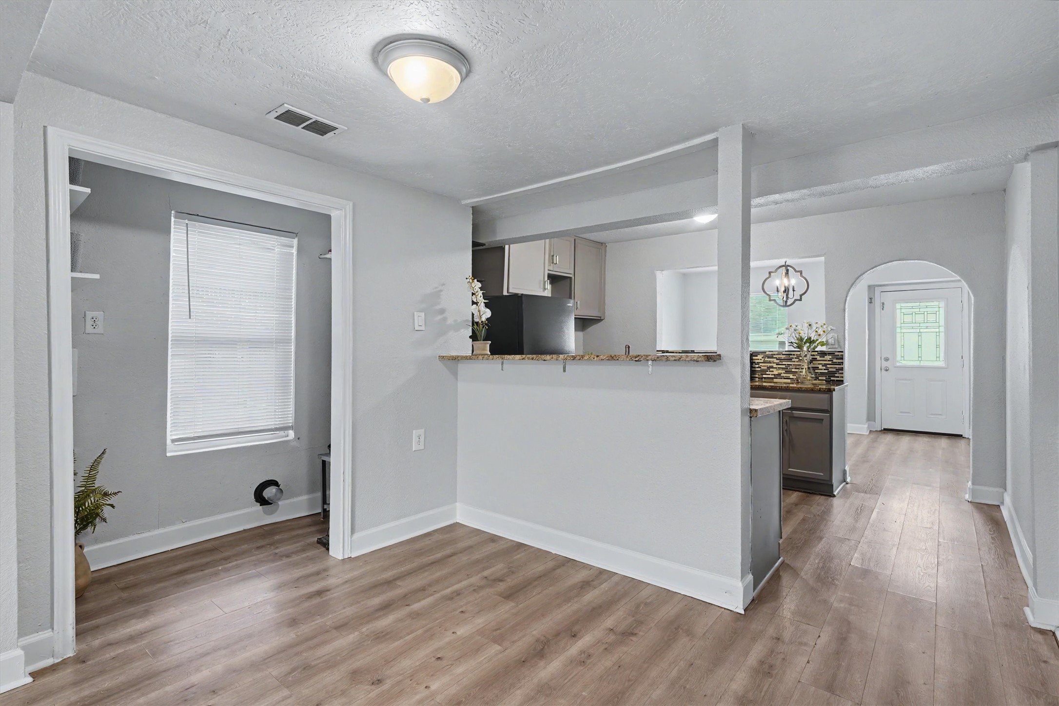 Open living area flows easily into the kitchen and front flex space, creating a connected and functional layout.