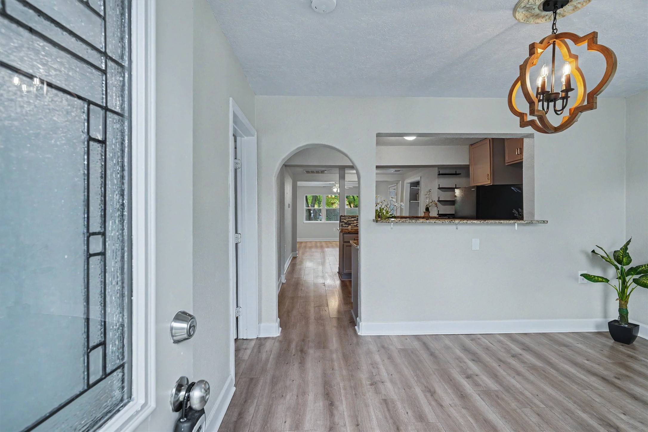 Flexible front room can serve as a dining area or den, with a breakfast bar opening to the kitchen.