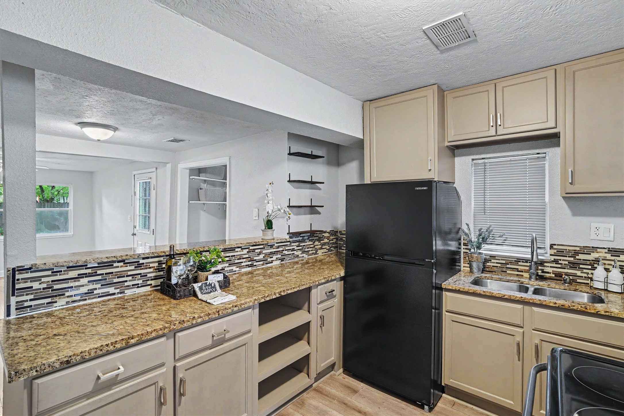 Plenty of counter and cabinet space, plus a new 2026 refrigerator that stays with the home.