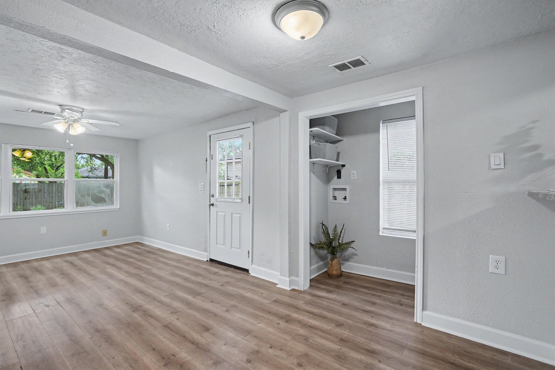 Another view of the living area with easy access to the kitchen and in-house utility/laundry room.