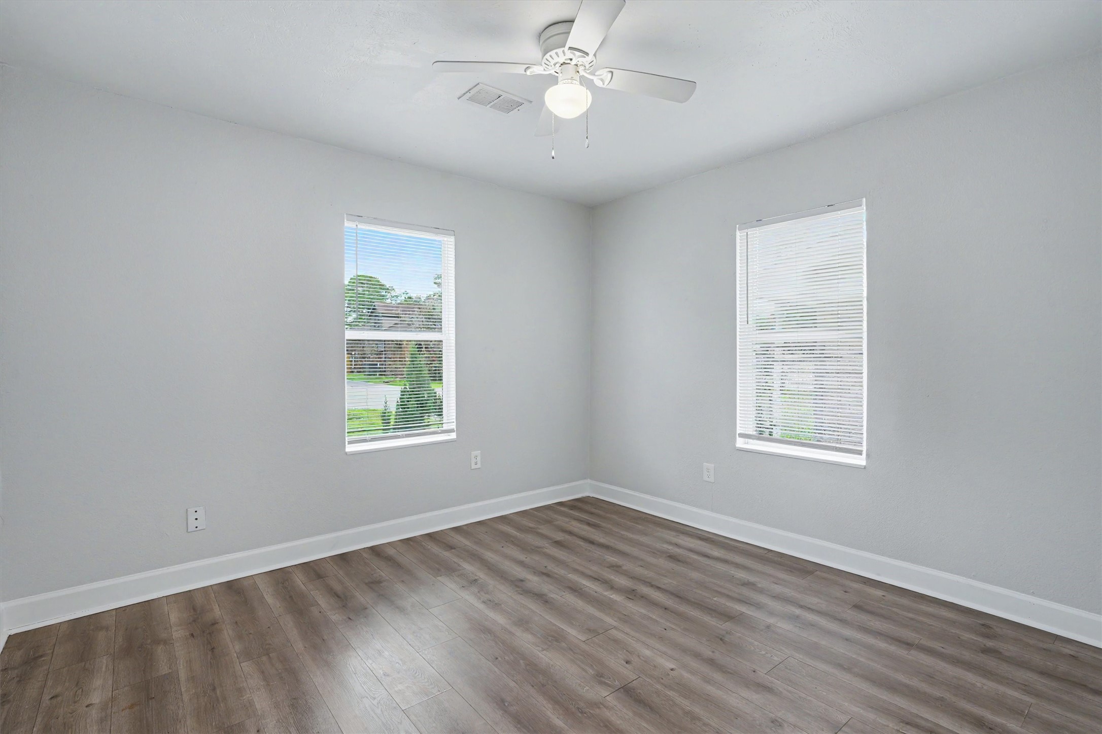 Two windows provide plenty of natural light in the primary bedroom.