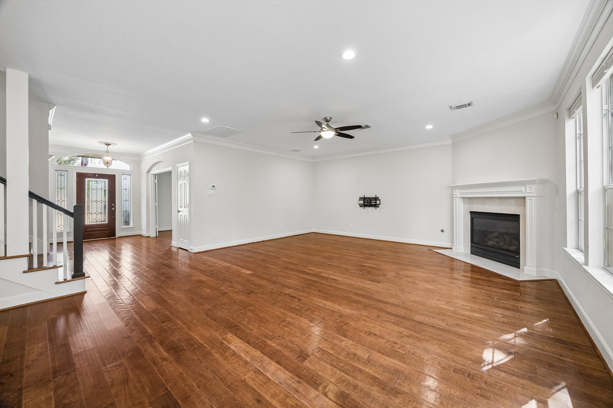 Expansive living area with an open layout, classic crown molding, and a seamless flow toward the front entry. Expansive living area with an open layout, classic crown molding, and a seamless flow toward the front entry.