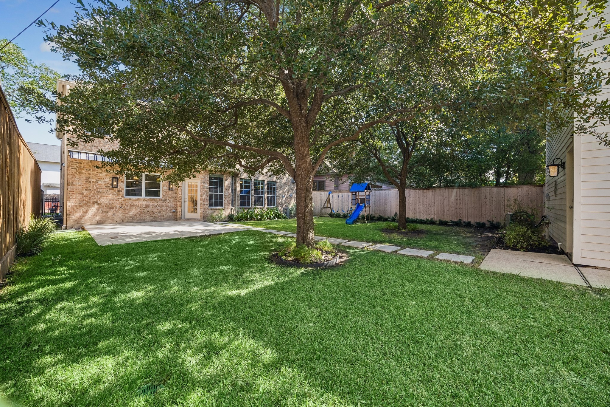 Spacious backyard with mature trees and ample room for a pool, creating the opportunity to design your ideal outdoor retreat.