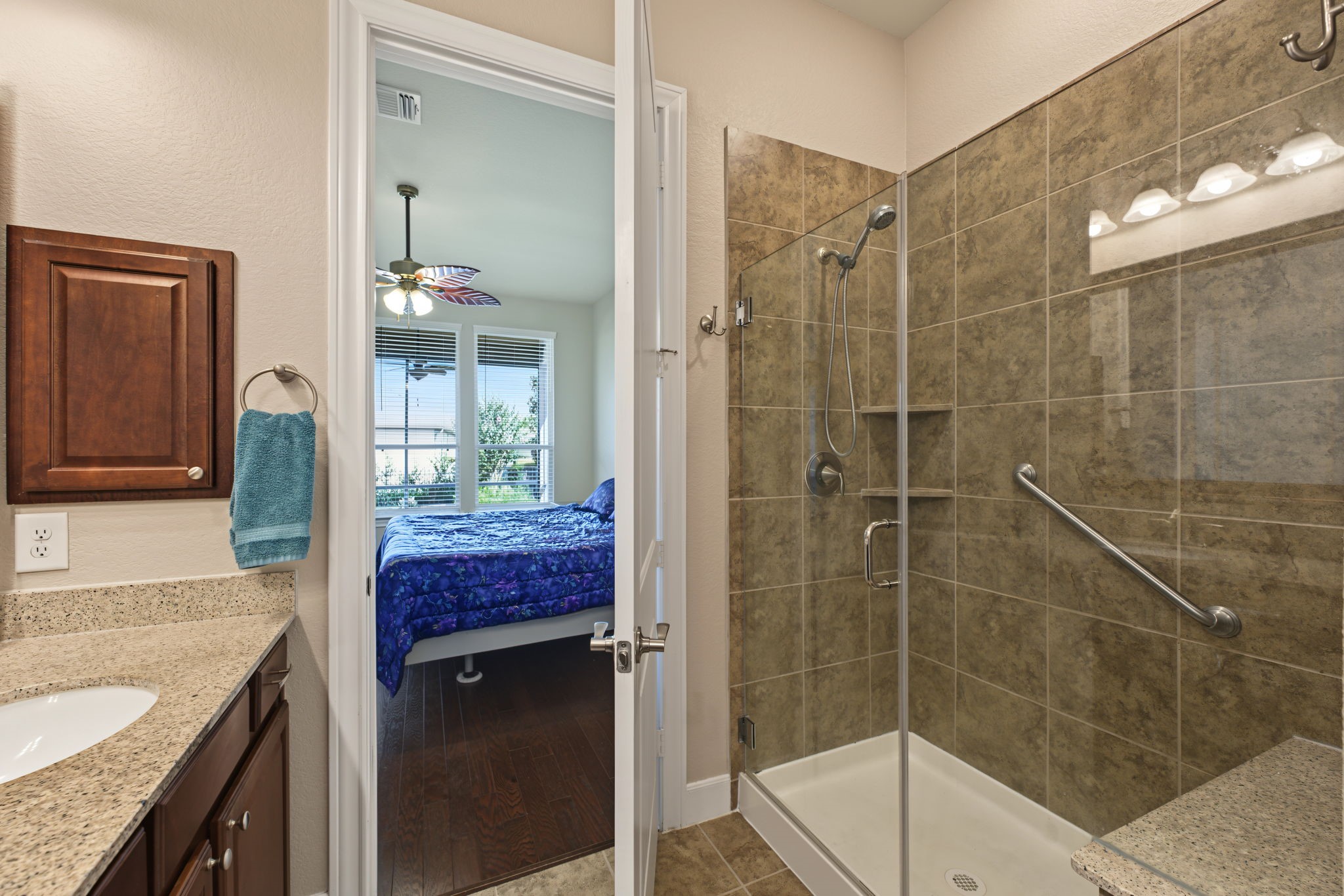 Primary bathroom features a shower with a bench