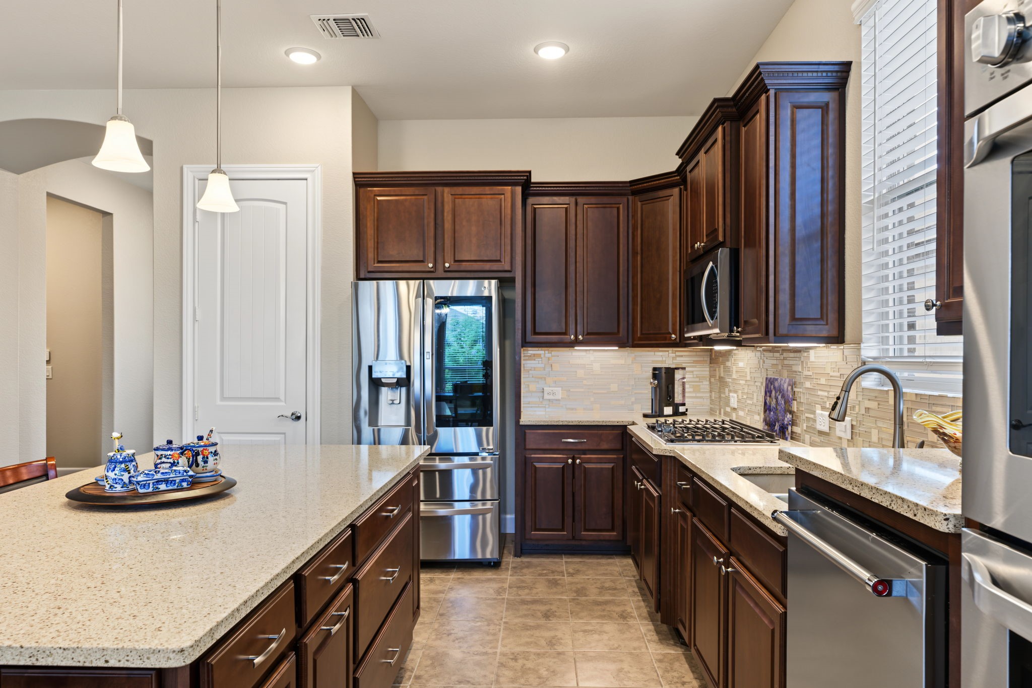 Gourmet gas cooktop and the refrigerator stays.