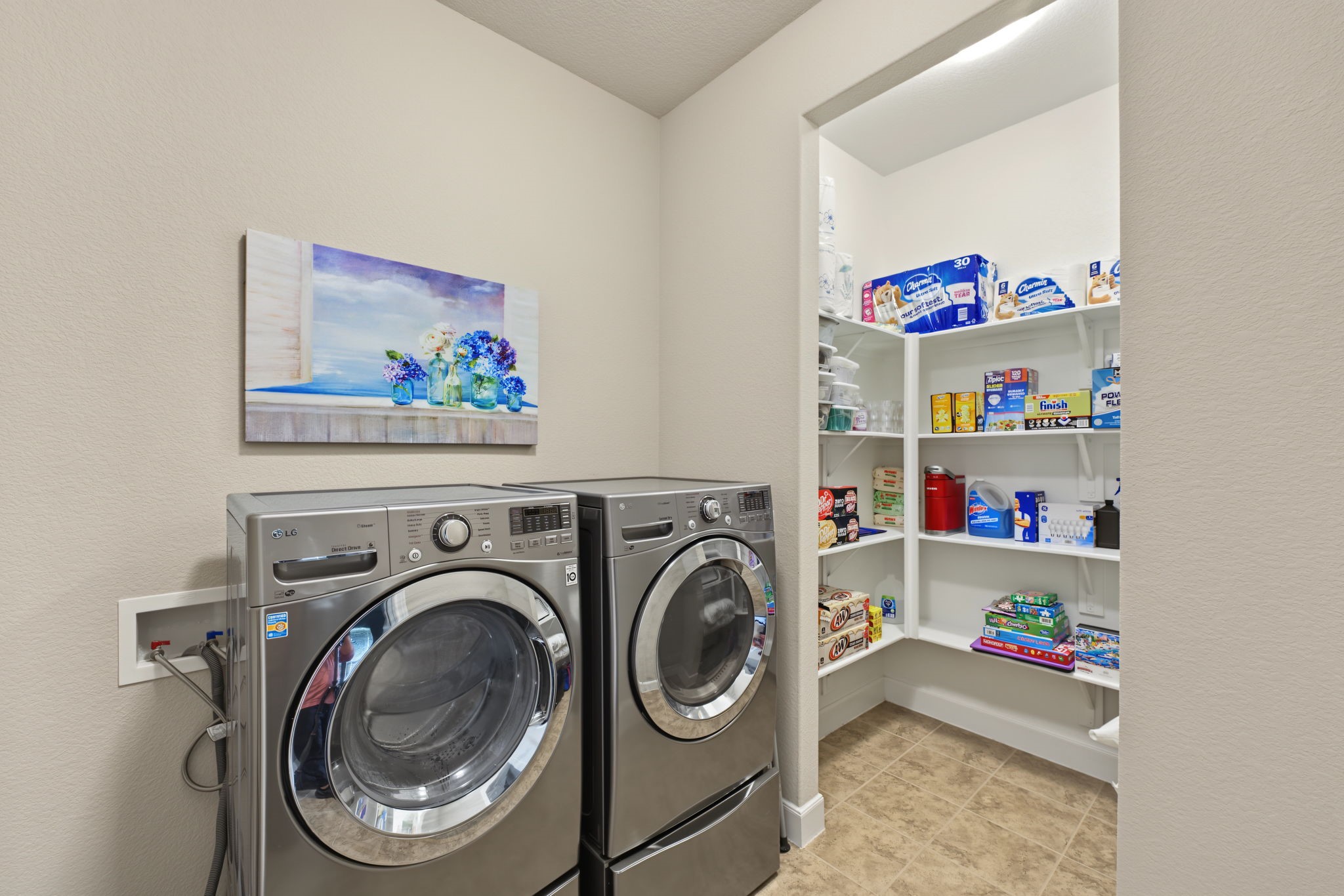 Adjacent to the utility room is shelving for extra storage