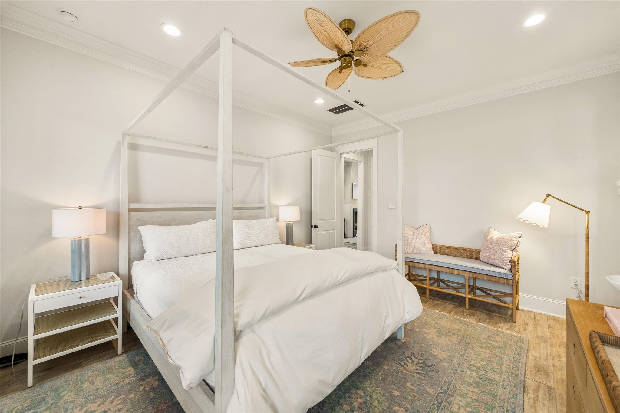 Primary suite is full of light. Plantation shutters can be drawn for relaxation