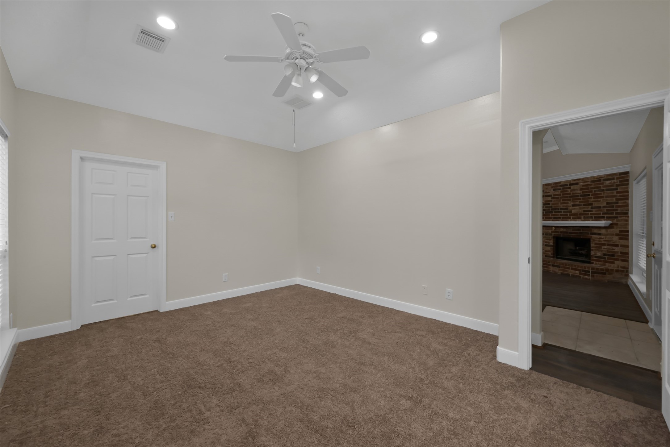 Primary Bedroom looking at the walk in closet and the Living room.