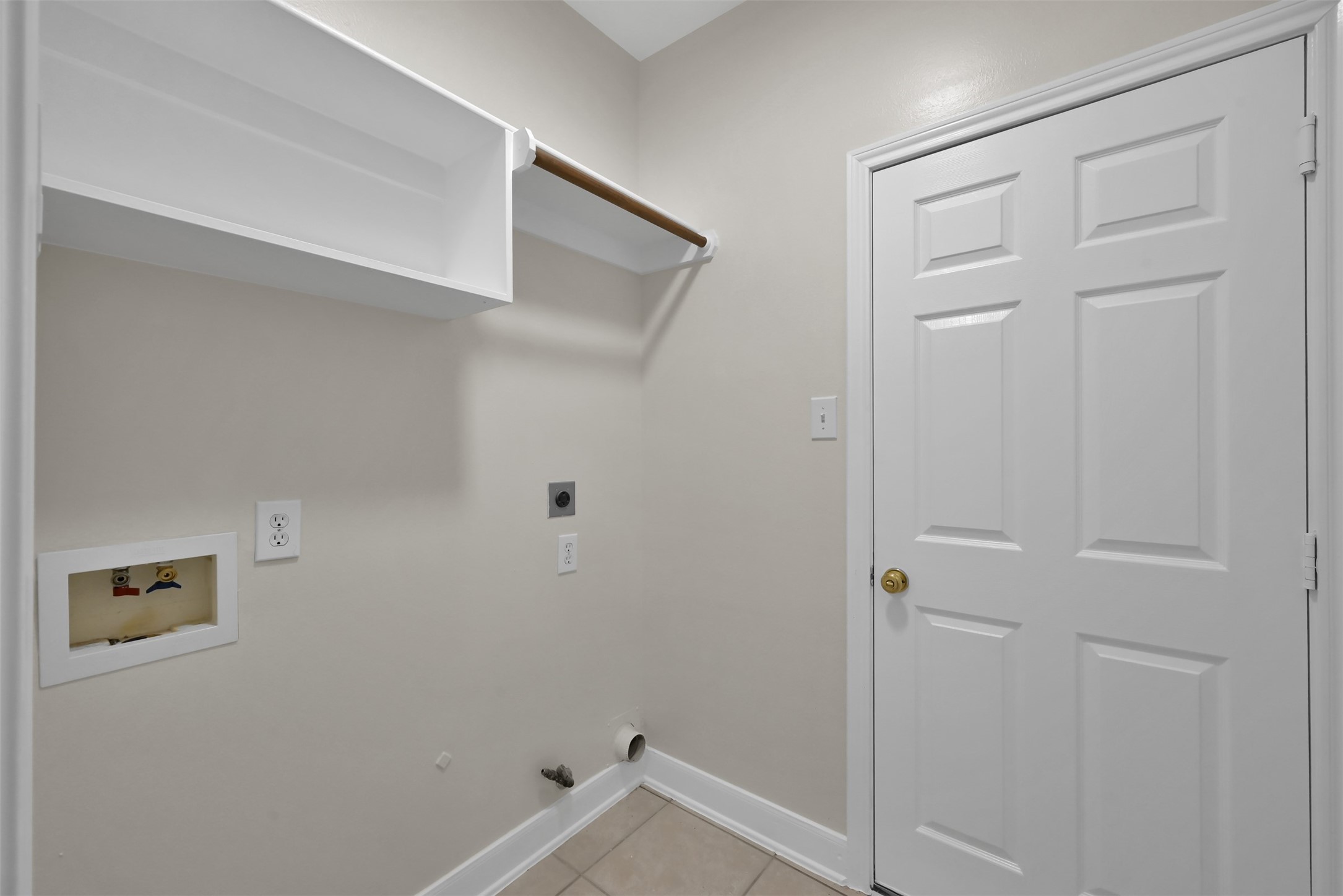 Laundry room with entrance to the Garage.