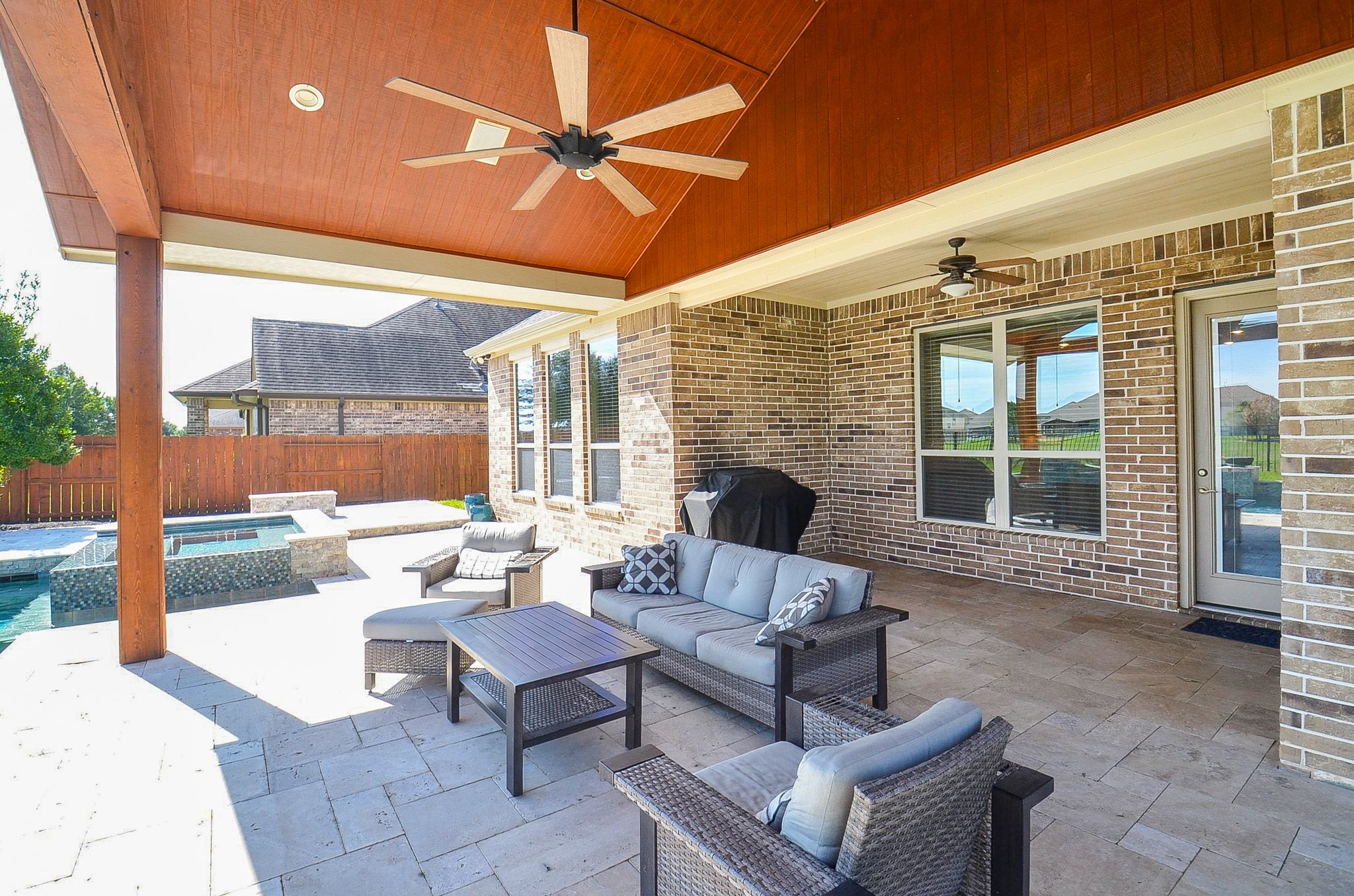 Spacious backyard patio featuring stunning views of the pool and lake!