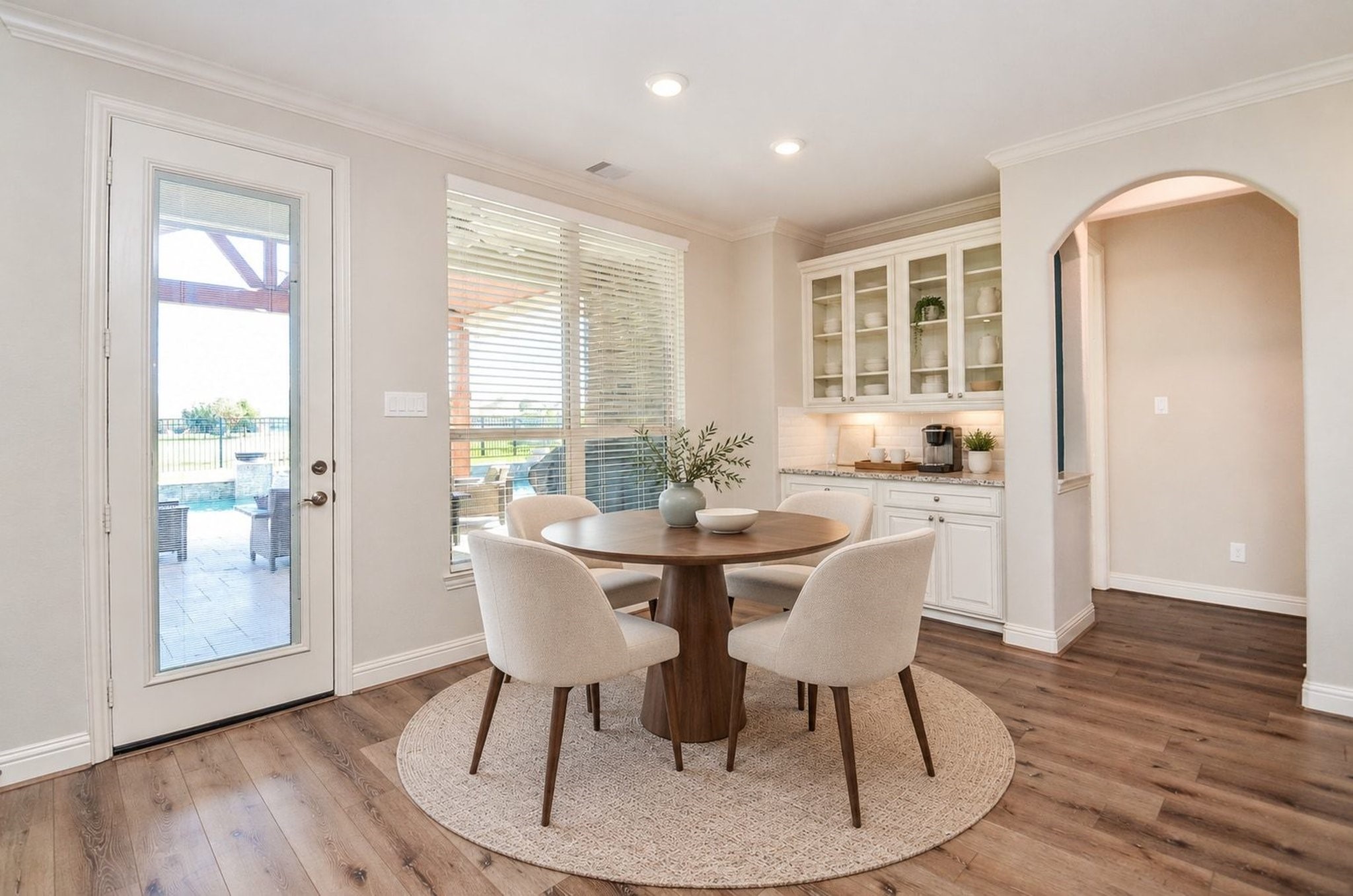 Spacious breakfast room featuring custom built-in cabinetry with elegant glass-front displays, perfect for showcasing your fine china and dinnerware!