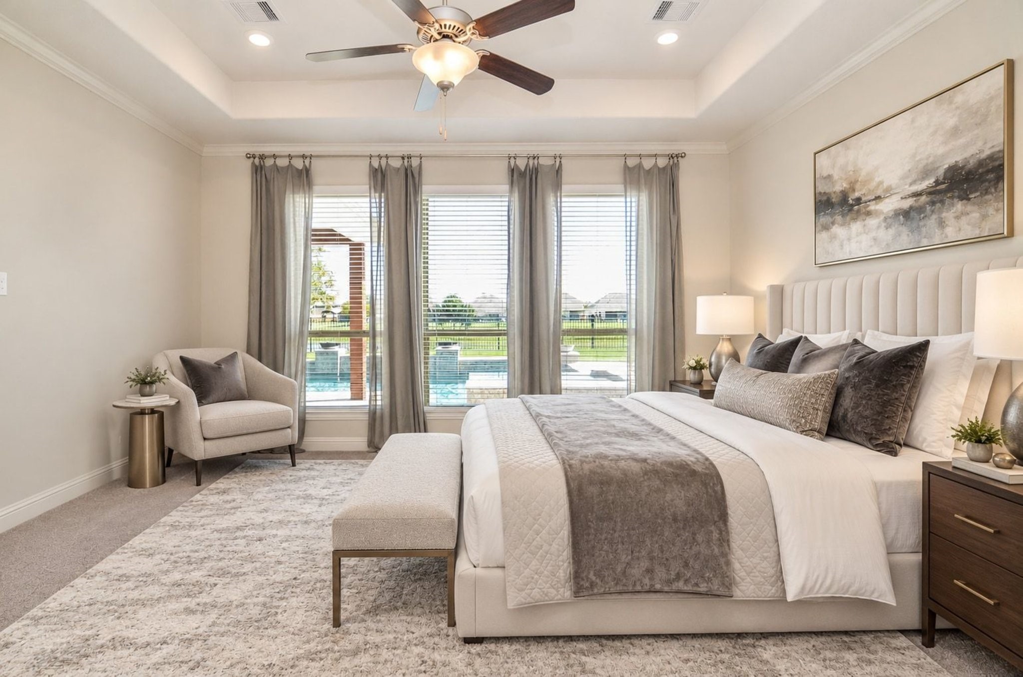Master bedroom featuring large windows with views of the pool and lake!