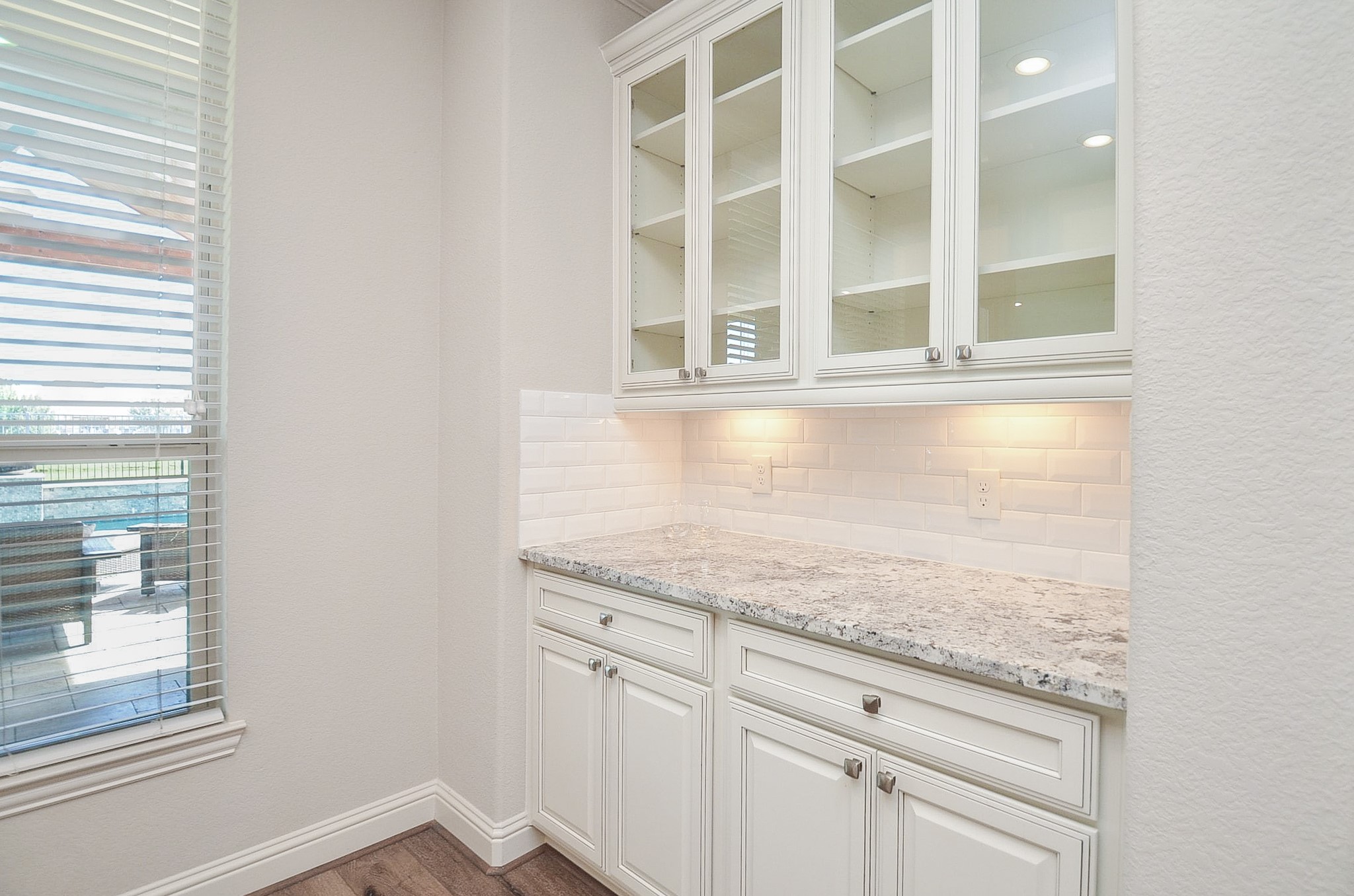 Custom built-in cabinetry with elegant glass-front displays, perfect for showcasing your fine china and dinnerware!