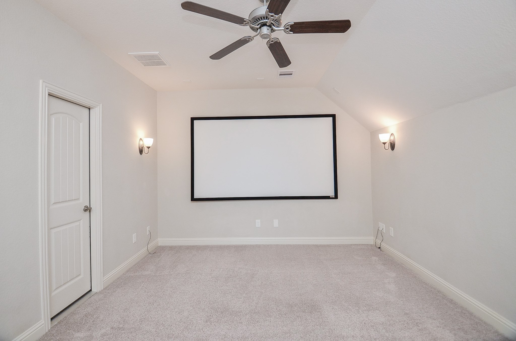 Media room featuring a projector screen and room for professional-grade seating!