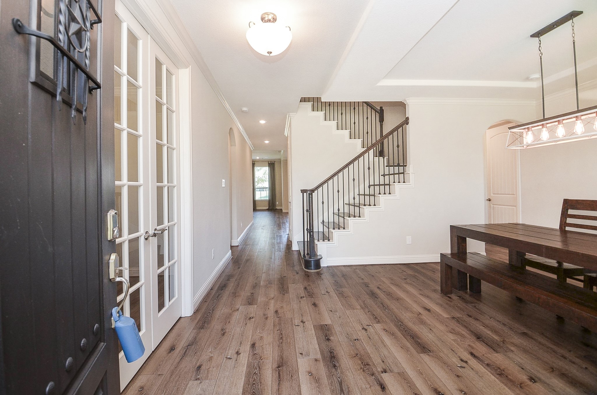 Step through the beautiful front door into a grand entrance featuring a stunning iron stairwell!