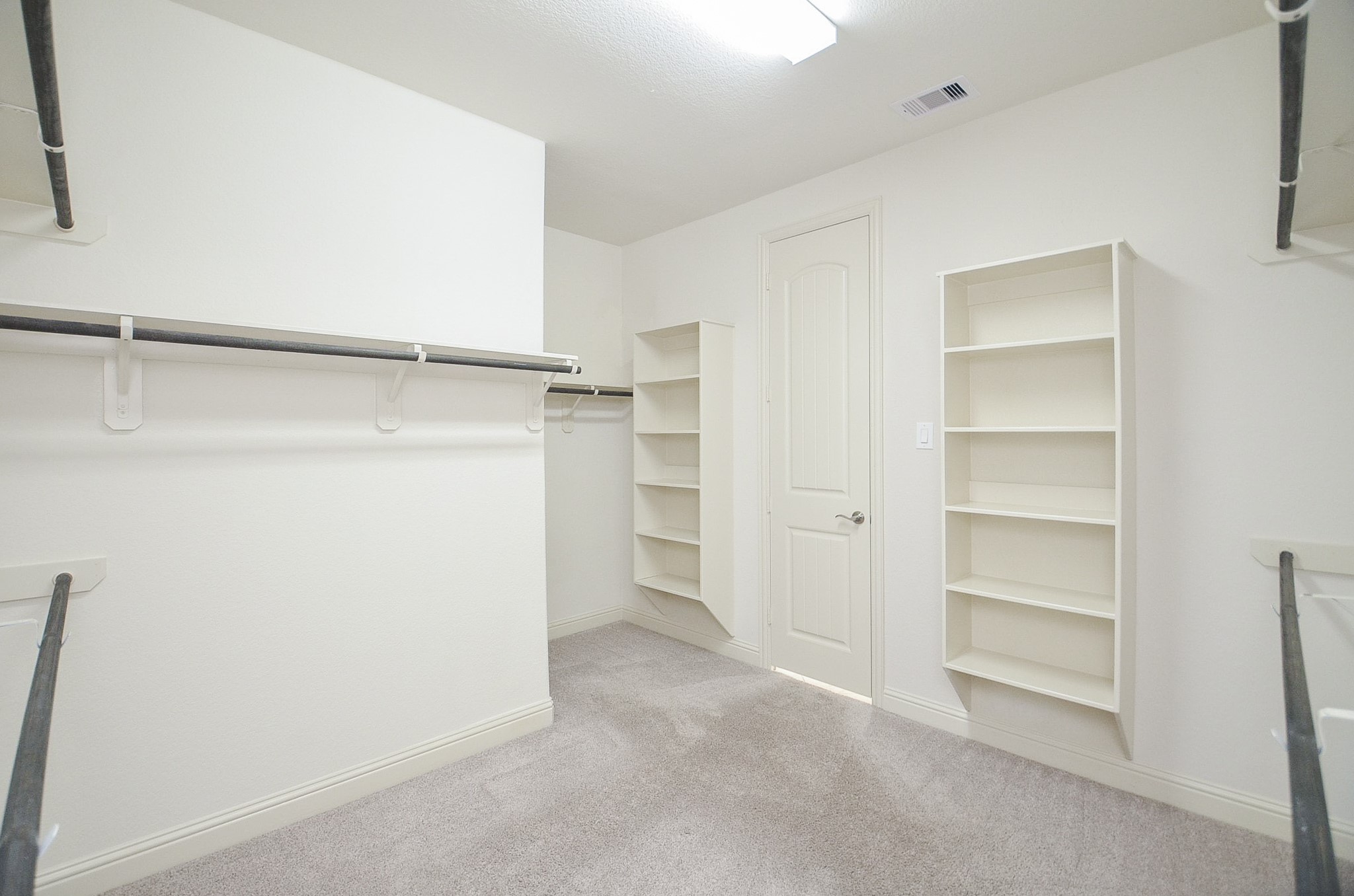 Spacious walk-in closet with custom shelving and ample storage space!