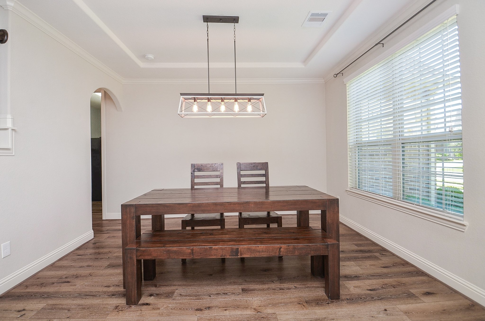 Beautiful dining area upon entry featuring a large window and an upgraded light fixture!