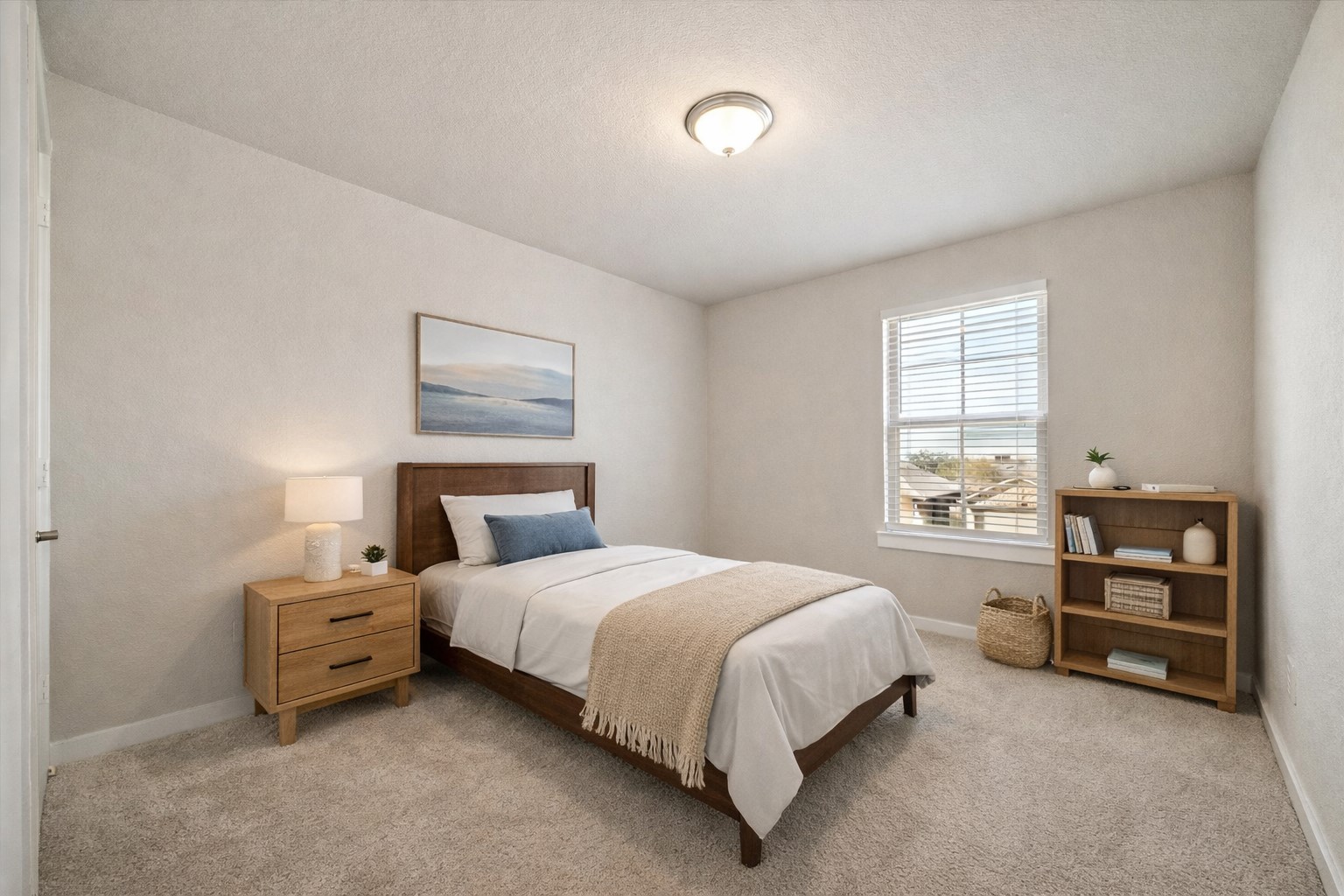 Clean lines and neutral tones define this secondary bedroom, offering a flexible footprint for guest accommodations, a home office, or a quiet retreat. Soft natural light filters through the window, while simple architectural detailing and plush carpet provide a comfortable, understated backdrop ready for personalization. *Virtually staged*