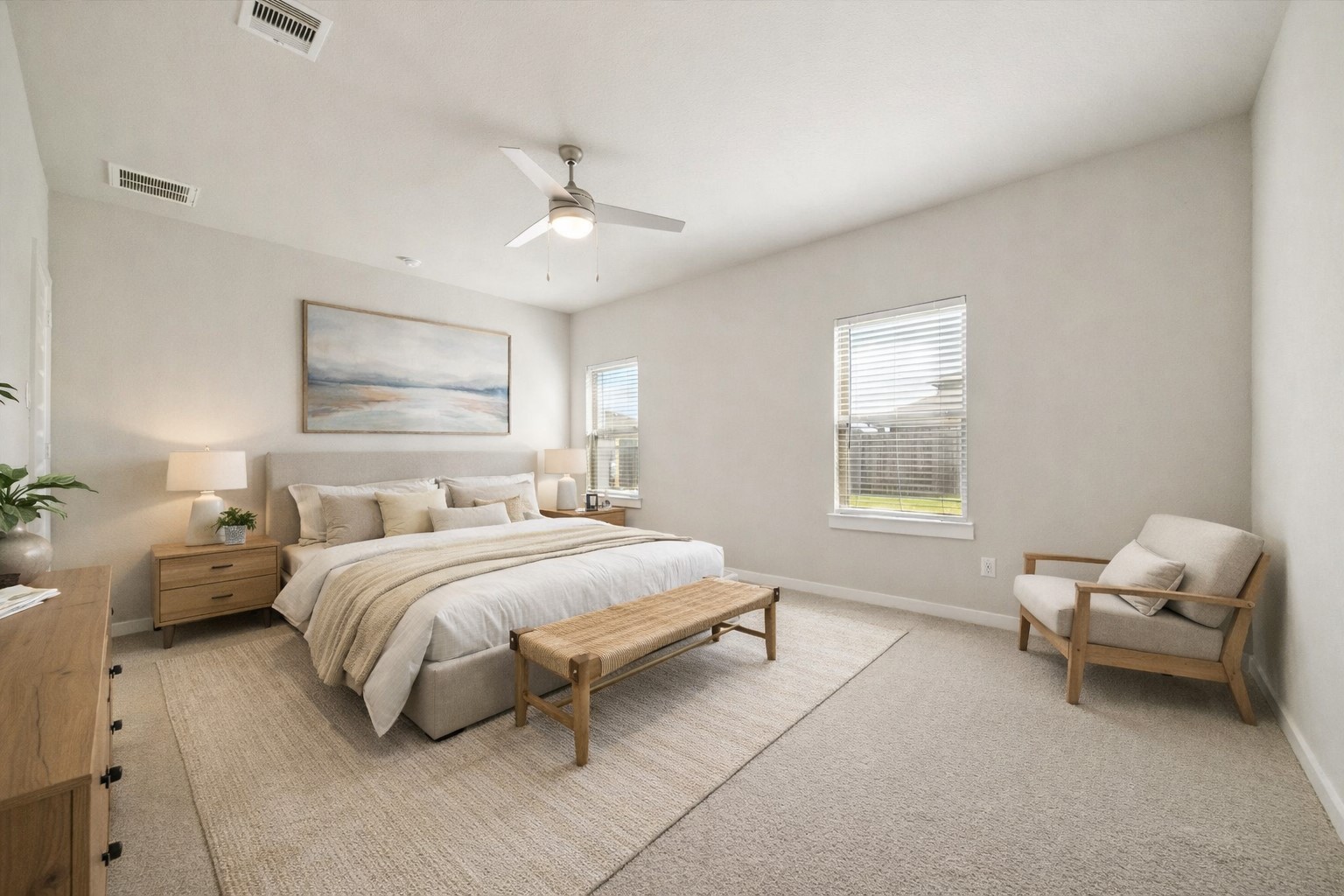Generous proportions and soft natural light define this primary bedroom, offering flexibility for large furniture, home office, or playroom. Neutral walls and plush carpeting create a calm foundation. *Virtually staged*